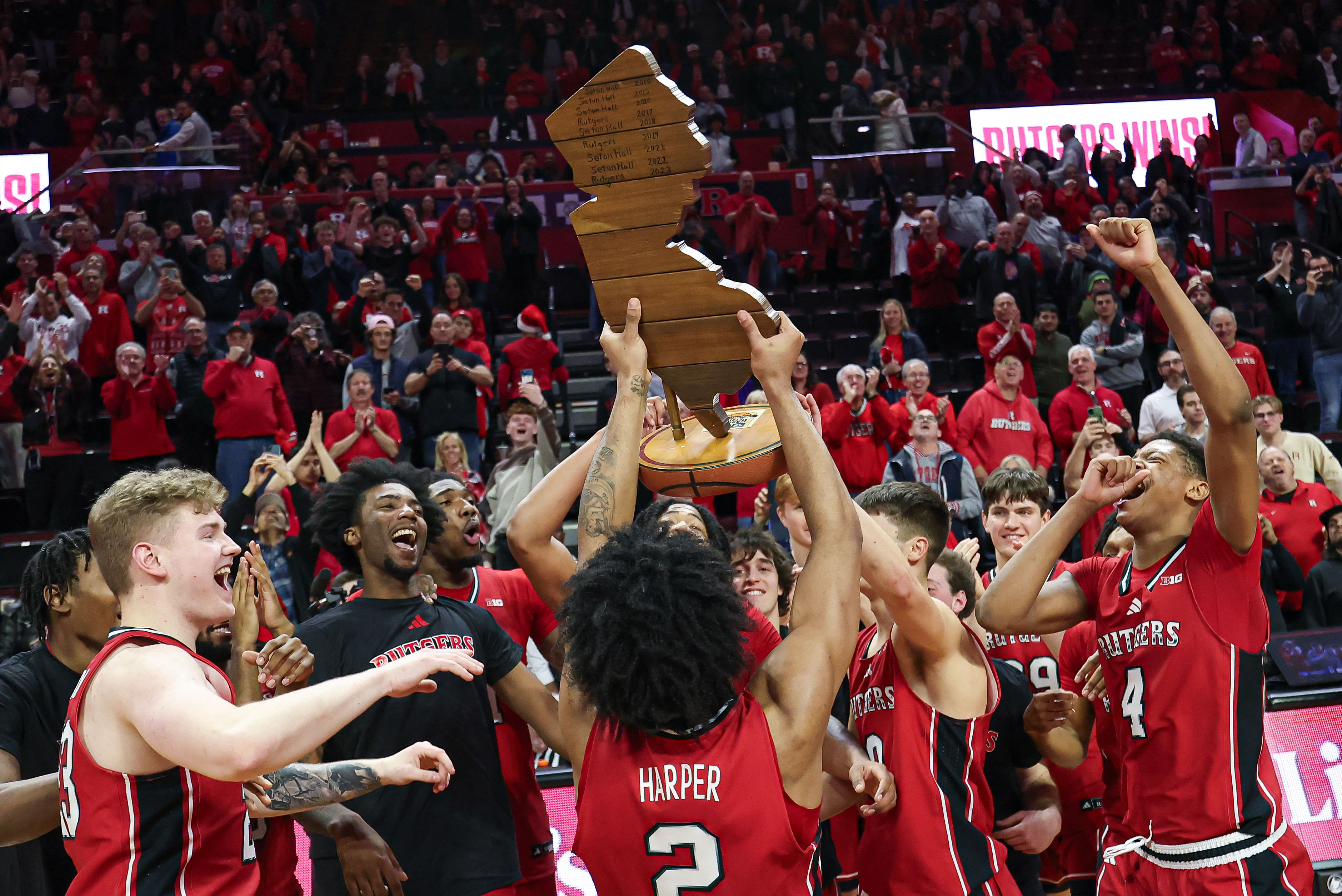 Rutgers Scarlet Knights guard Dylan Harper (2) celebrates with his teammates after they captured the Garden State Hardwood Classic trophy following their win over Seton Hall. Photo: Imagn