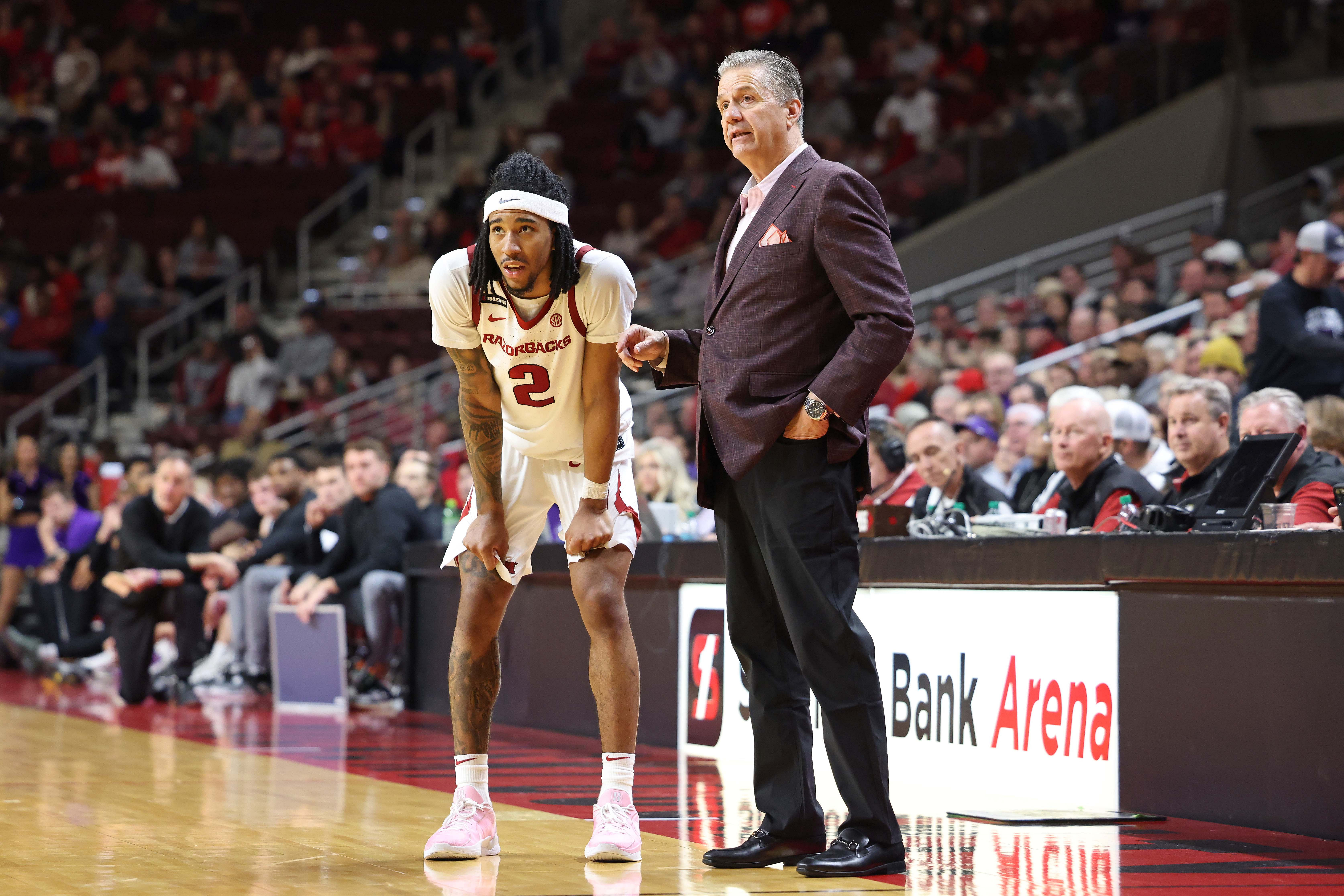 Arkansas Razorbacks guard Boogie Fland (2) receives instructions from coach John Calipari during an NCAA Basketball game. (Credits: IMAGN)