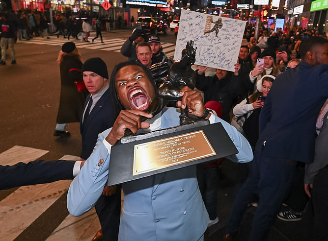 “What’s with the shirt”: CFB fans react as old image of Travis Hunter with dad goes viral following Heisman ceremony shoutout