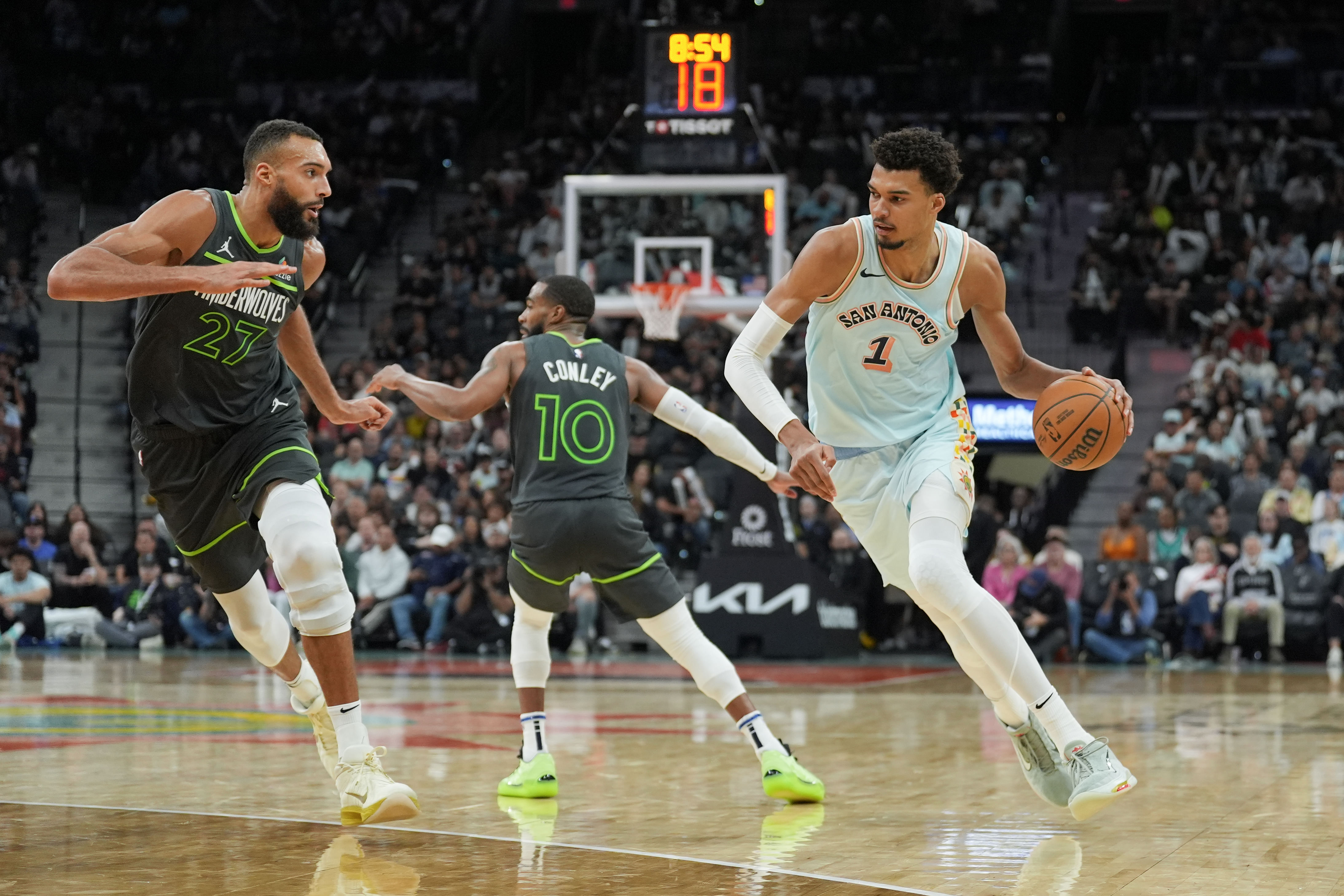 San Antonio Spurs center Victor Wembanyama dribbles against Minnesota Timberwolves center Rudy Gobert at Frost Bank Center. Photo Credit: Imagn