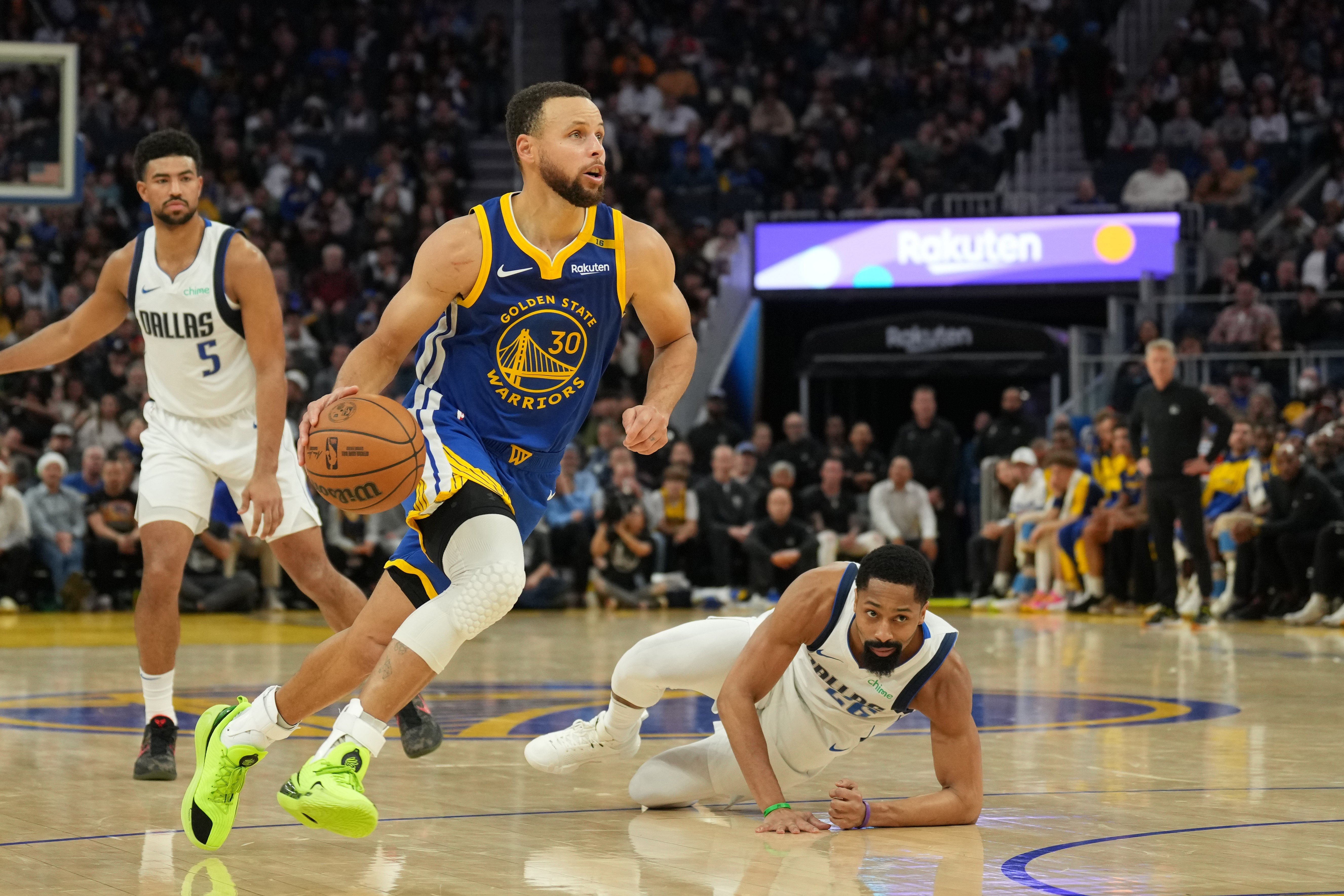 Dec 15, 2024; San Francisco, California, USA; Golden State Warriors guard Stephen Curry (30) dribbles after Dallas Mavericks guard Spencer Dinwiddie (right) falls to the floor during the third quarter at Chase Center. Mandatory Credit: Darren Yamashita-Imagn Images - Source: Imagn