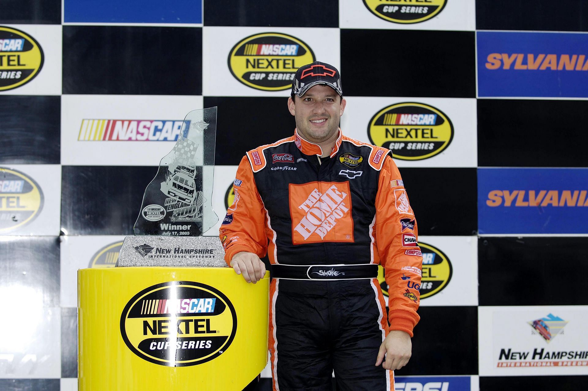 Tony Stewart, driver of the #20 Chevrole, poses for photos with the trophy after winning the 2005 NASCAR Nextel Cup Series - Source: Getty Images