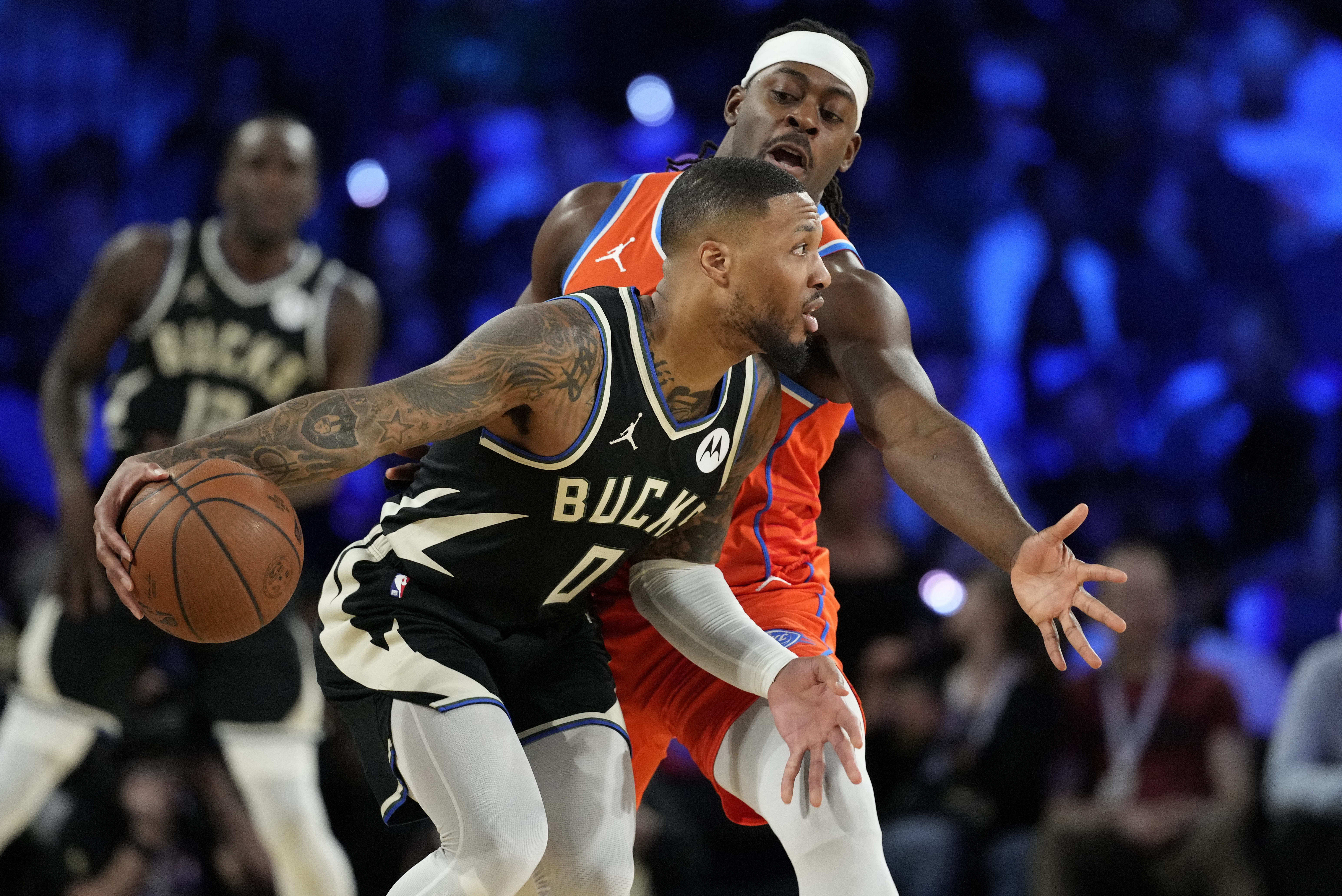 Milwaukee Bucks guard Damian (0) dribbles against Oklahoma City Thunder guard Luguentz Dort (5) during the 1st quarter of the Emirates NBA Cup championship game at T-Mobile Arena. Mandatory Credit: Kyle Terada-Imagn Images