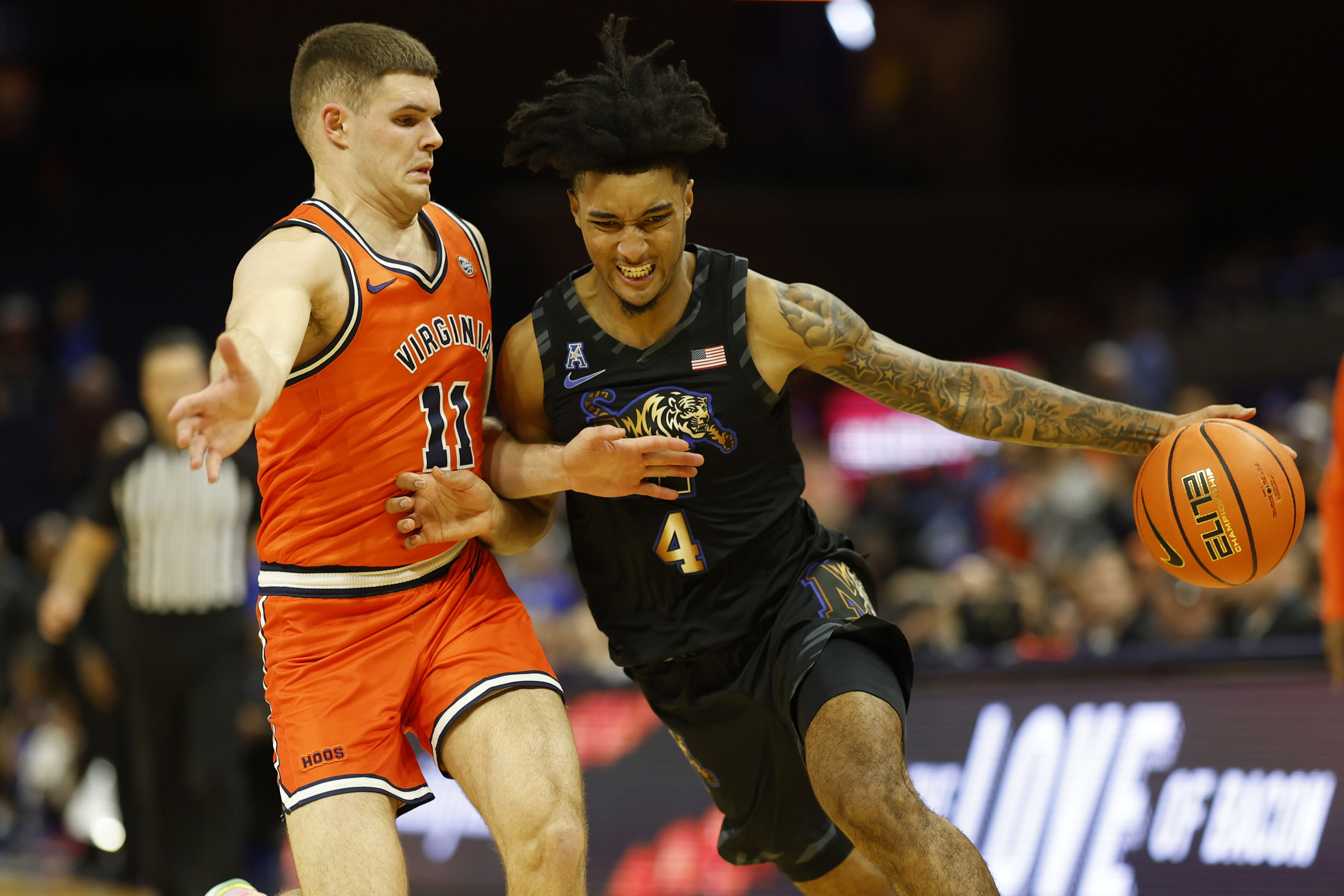 Memphis Tigers guard PJ Haggerty (#4) drives to the basket against the Virginia Cavaliers. Photo: Imagn