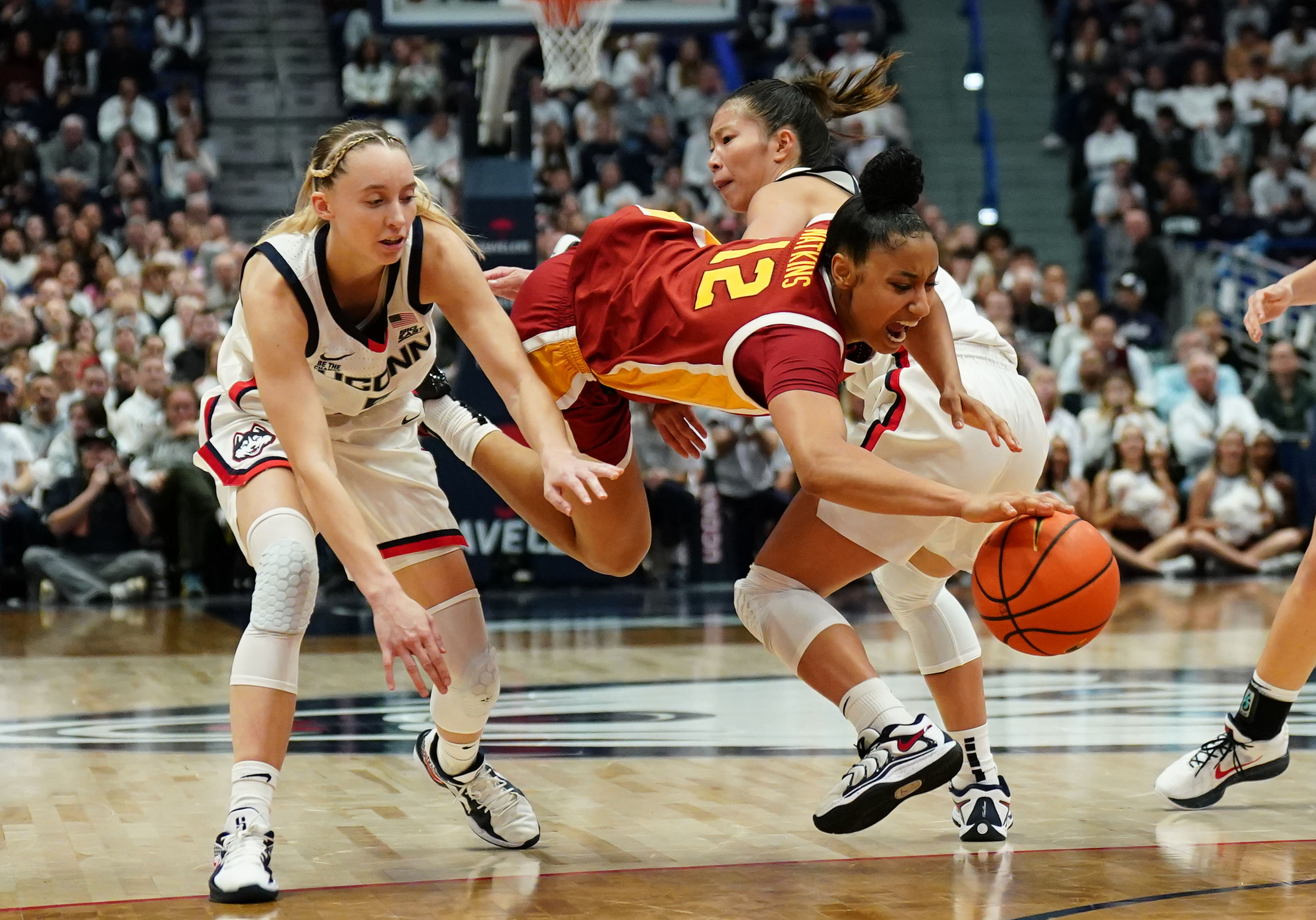 USC Trojans guard JuJu Watkins (#12) drives the ball against UConn Huskies guards Paige Bueckers (#5) and Kaitlyn Chen (#20) in the second half at XL Center. Photo: Imagn