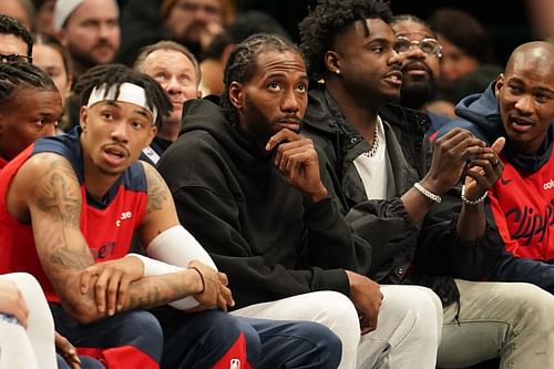 Kawhi Leonard looks on from the bench in street clothes during the game against the Dallas Mavericks during the second half at American Airlines Center. Mandatory Credit: Chris Jones-Imagn Images