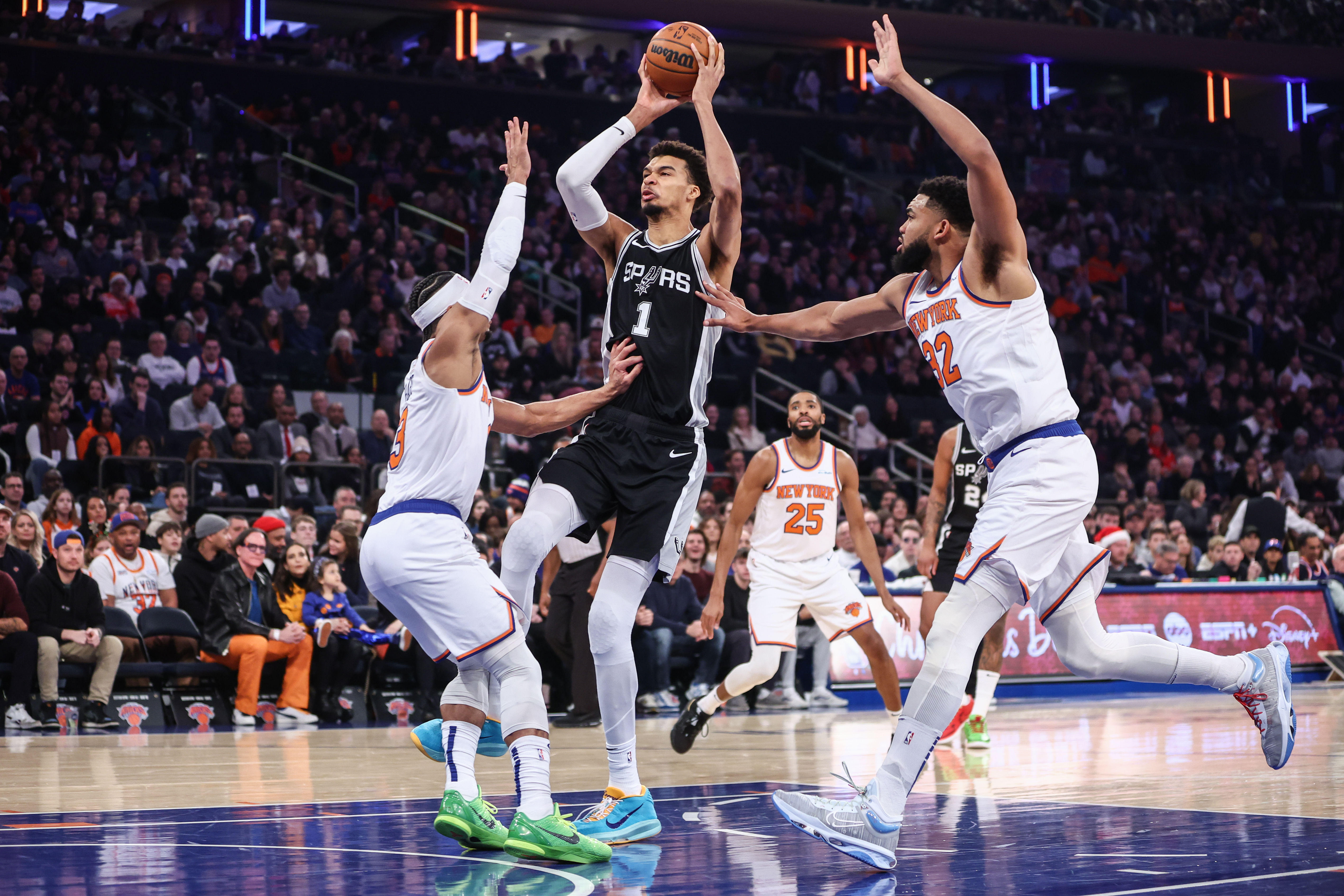 San Antonio Spurs center Victor Wembanyama (1) looks to drive past New York Knicks guard Josh Hart (3) and center Karl-Anthony Towns (32) in the first quarter at Madison Square Garden. Mandatory Credit: Wendell Cruz - Source: Imagn