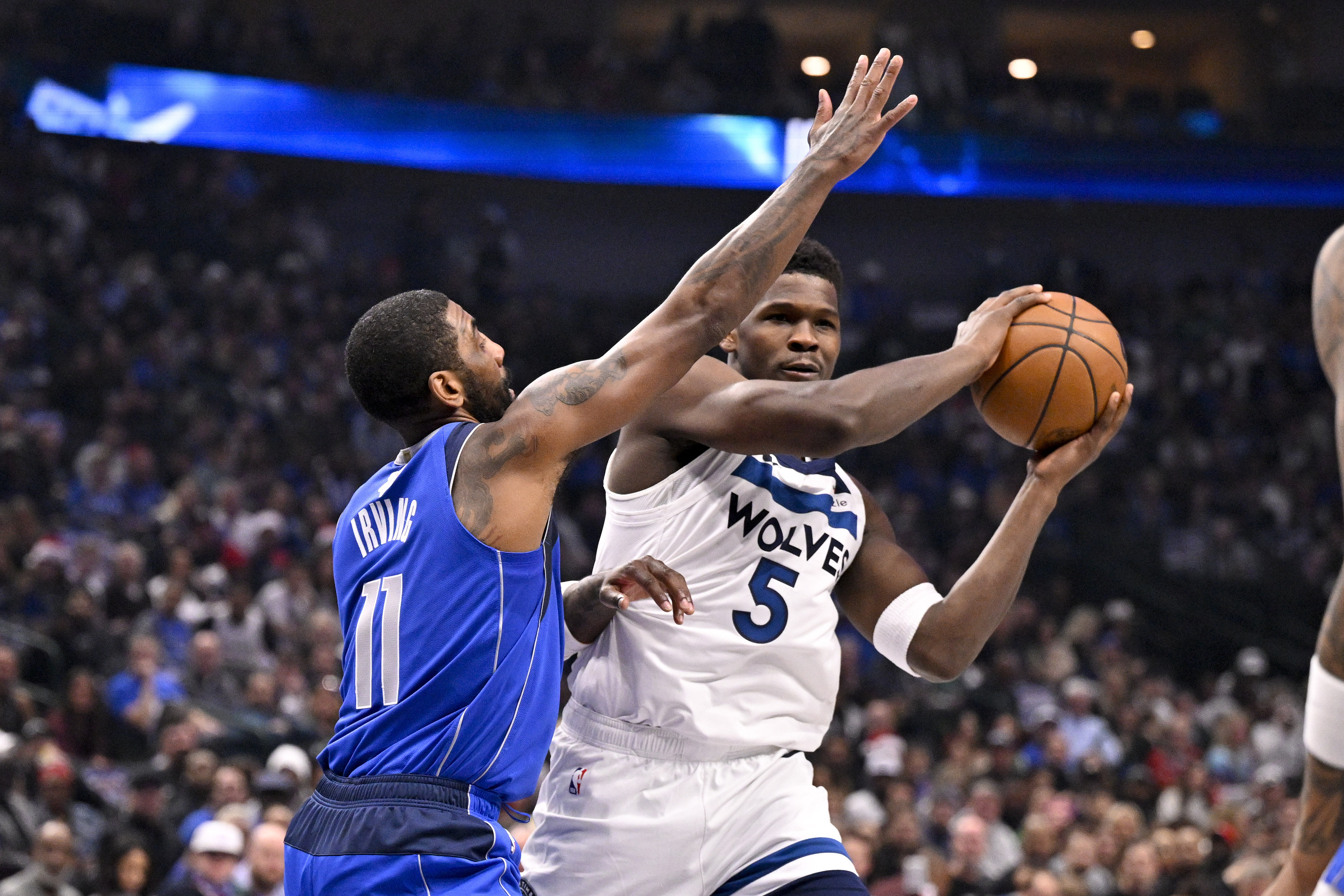 Minnesota Timberwolves guard Anthony Edwards (5) looks to pass the ball past Dallas Mavericks guard Kyrie Irving (11) - Source: Imagn