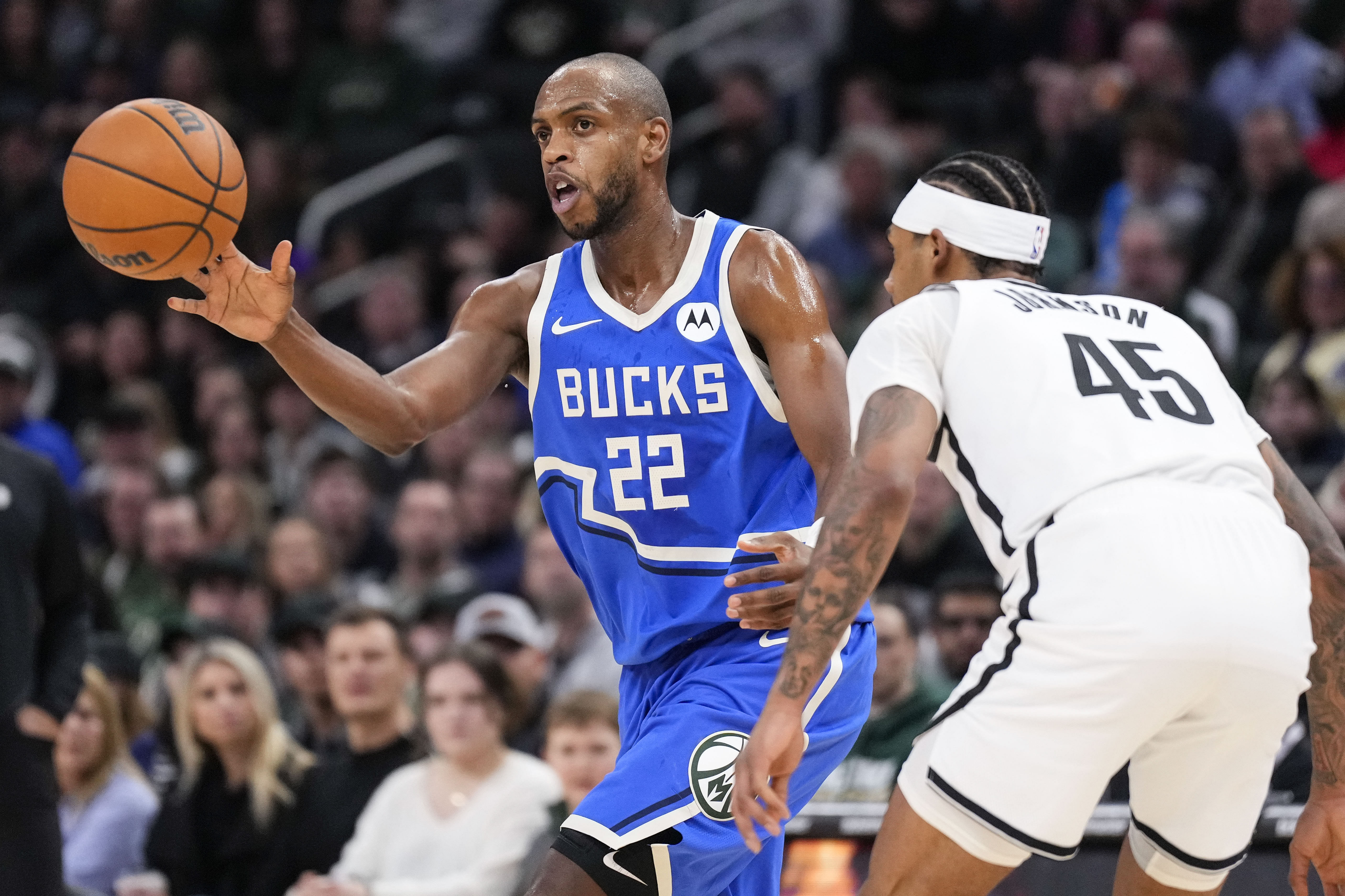 Milwaukee Bucks forward Khris Middleton passes the ball as Brooklyn Nets guard Keon Johnson defends at Fiserv Forum. Photo Credit: Imagn