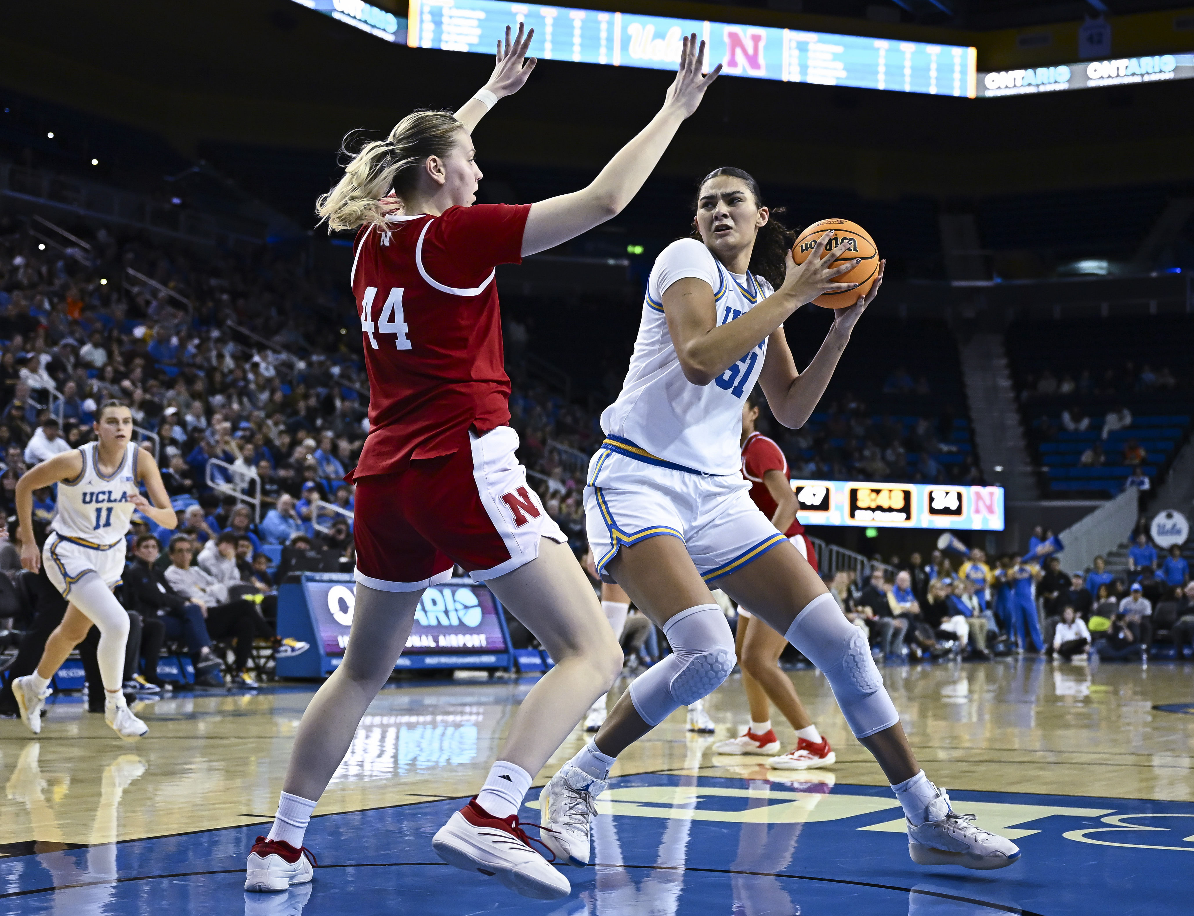 UCLA Bruins center Lauren Betts (#51) drives to the basket as Nebraska Cornhuskers forward Petra Bozan (44) defends during the third quarter of their NCAA game at Pauley Pavilion. Photo: Imagn