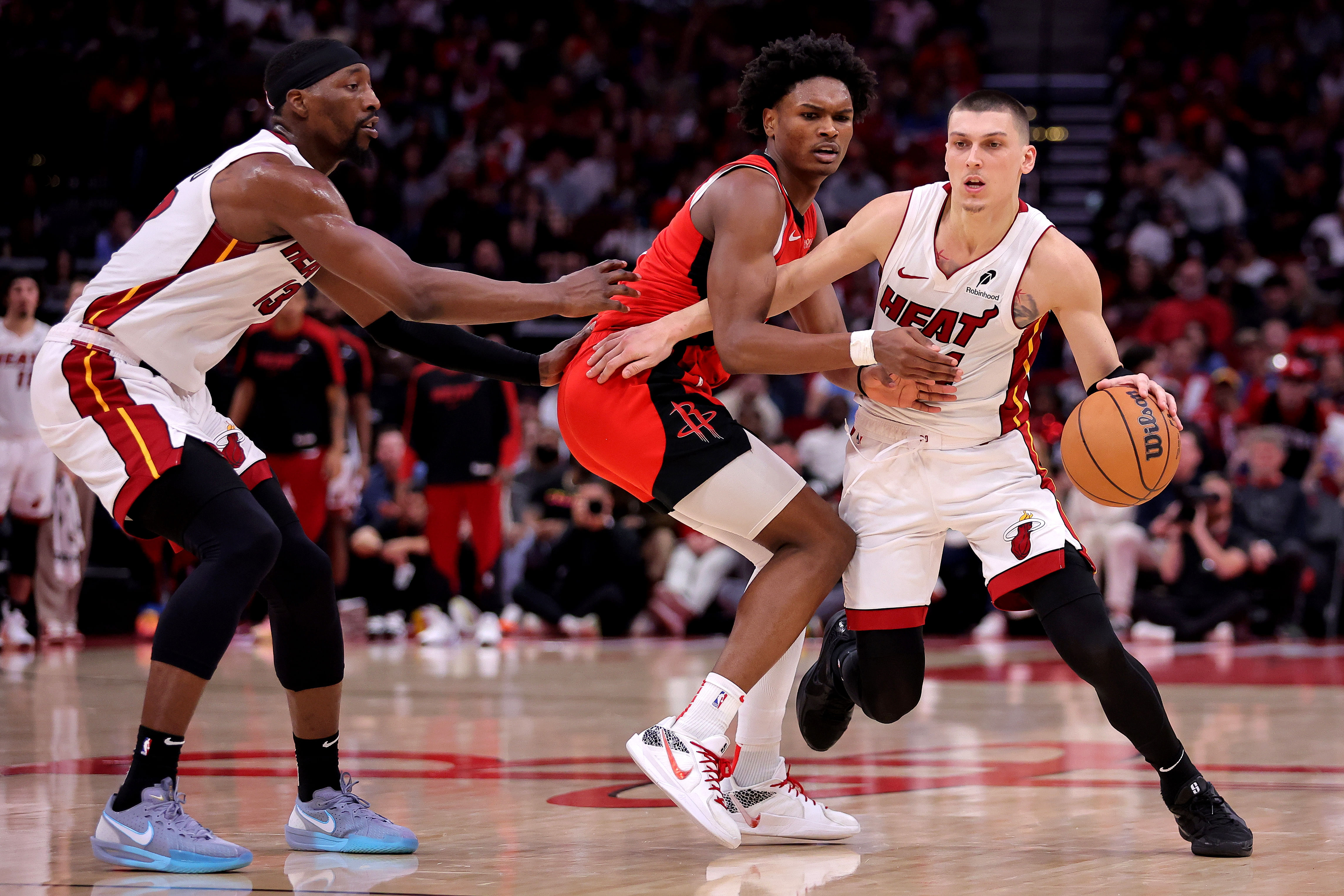 Dec 29, 2024; Houston, Texas, USA; Miami Heat guard Tyler Herro (14) handles the ball against Houston Rockets guard Amen Thompson (1) during the fourth quarter at Toyota Center. Mandatory Credit: Erik Williams-Imagn Images - Source: Imagn