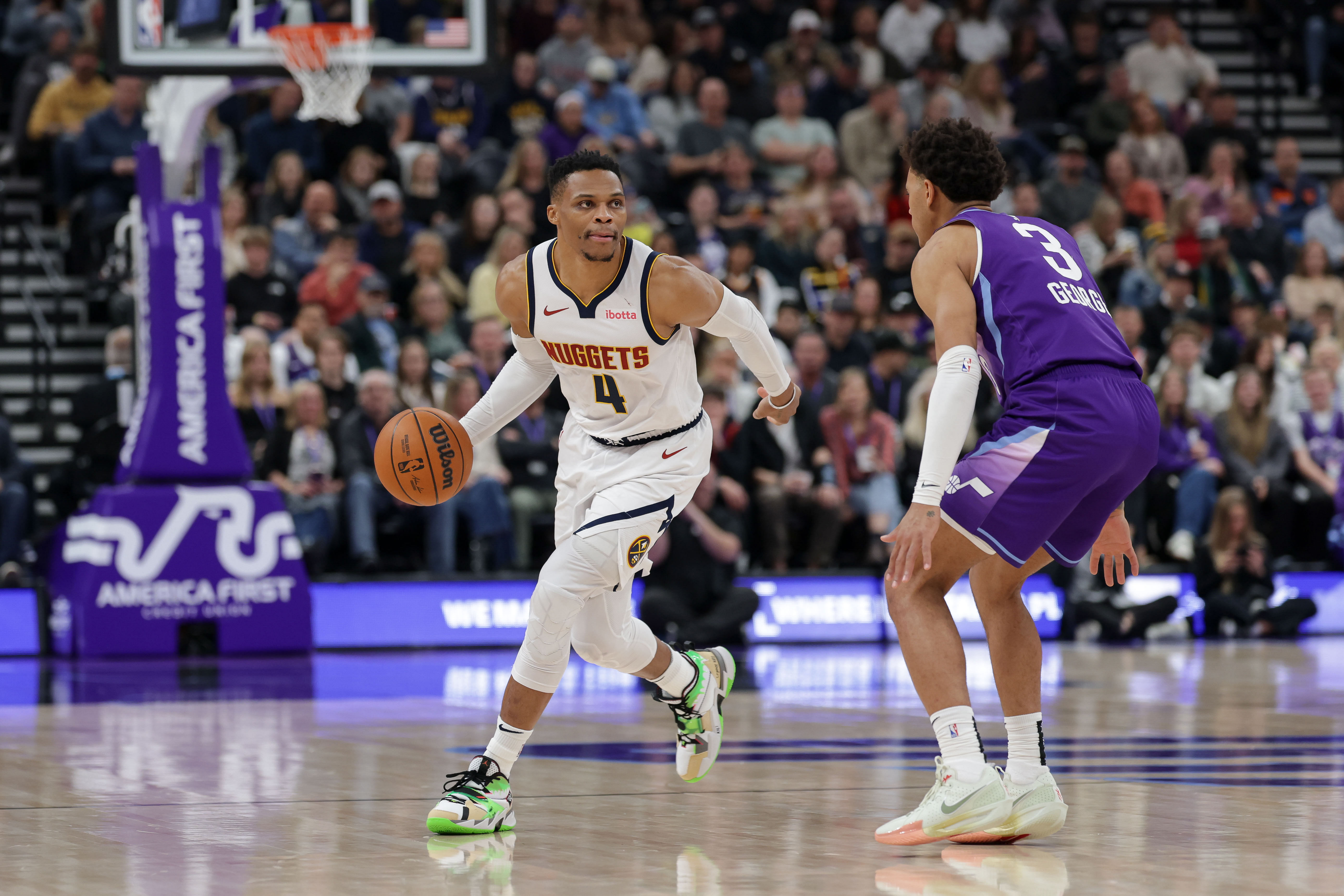 Dec 30, 2024; Salt Lake City, Utah, USA; Denver Nuggets guard Russell Westbrook (4) controls the ball while guarded by Utah Jazz guard Keyonte George (3) during the second quarter at Delta Center. Mandatory Credit: Chris Nicoll-Imagn Images - Source: Imagn