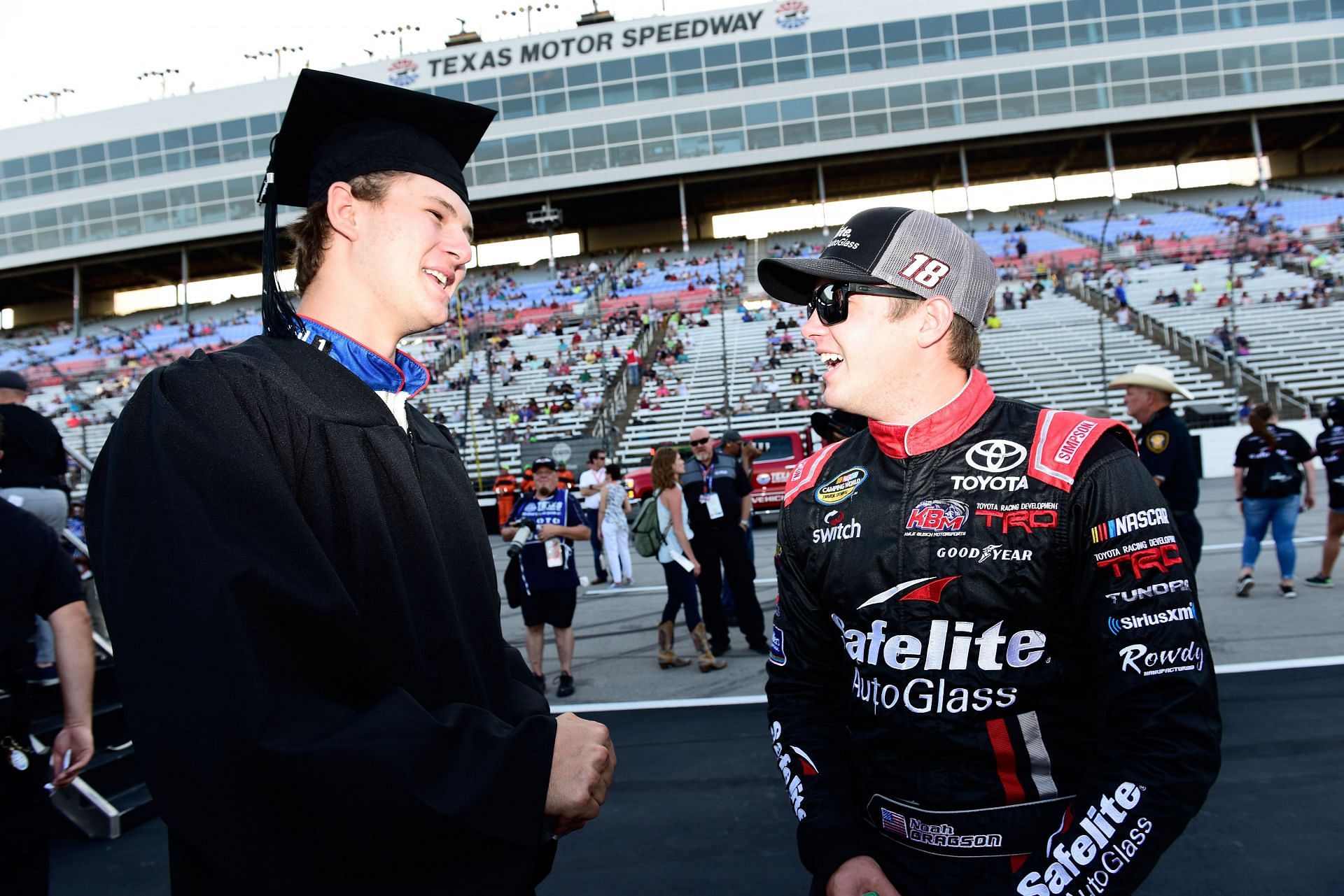 Todd Gilliland with Noah Gragson after receiving his diploma on stage prior to the NASCAR Camping World Truck Series PPG 400 at Texas Motor Speedway on June 8, 2018 - Source: Getty