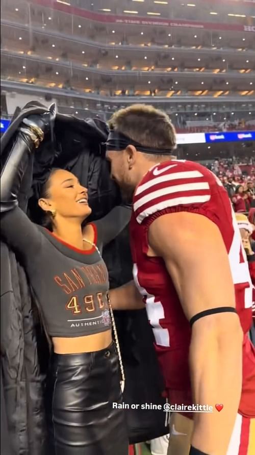 The Juszczyks kiss in the rain at Santa Clara