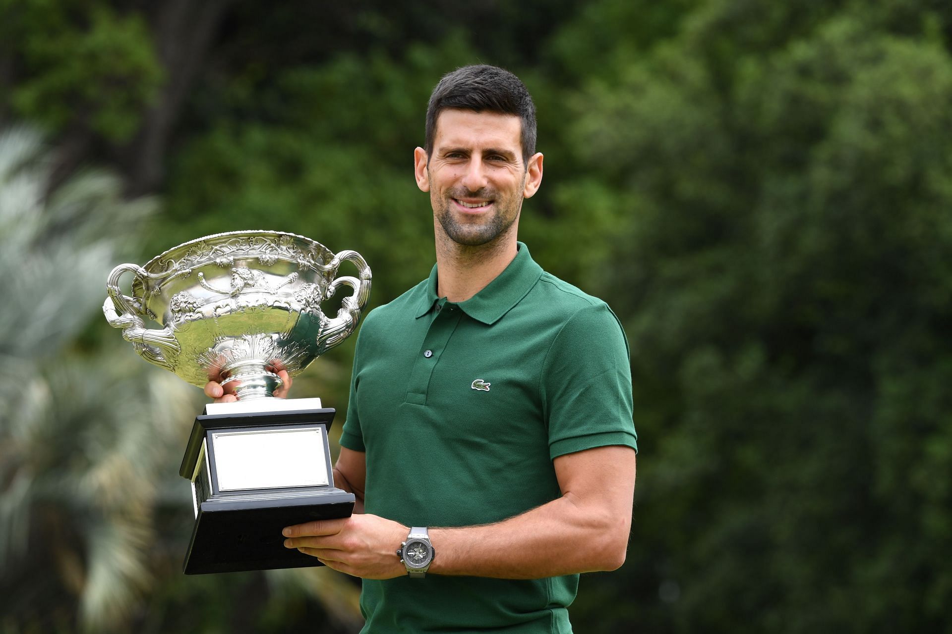 The Serb poses with his 10th Australian Open title