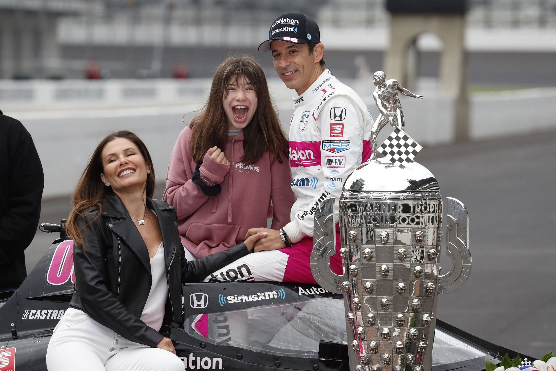 Helio Castroneves poses with his wife and daughter after his 4th Indy 500 win in 2021 - Source: Getty