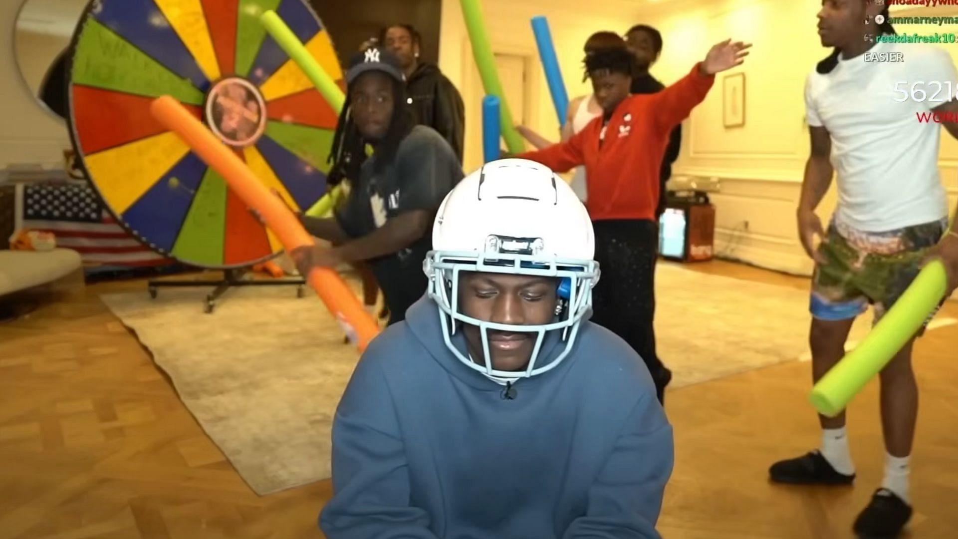 Kai winds up a strike while Lil Yachty braces himself in the Extreme Noodle Hitting Game (Image via Kai Cenat Live/YouTube)