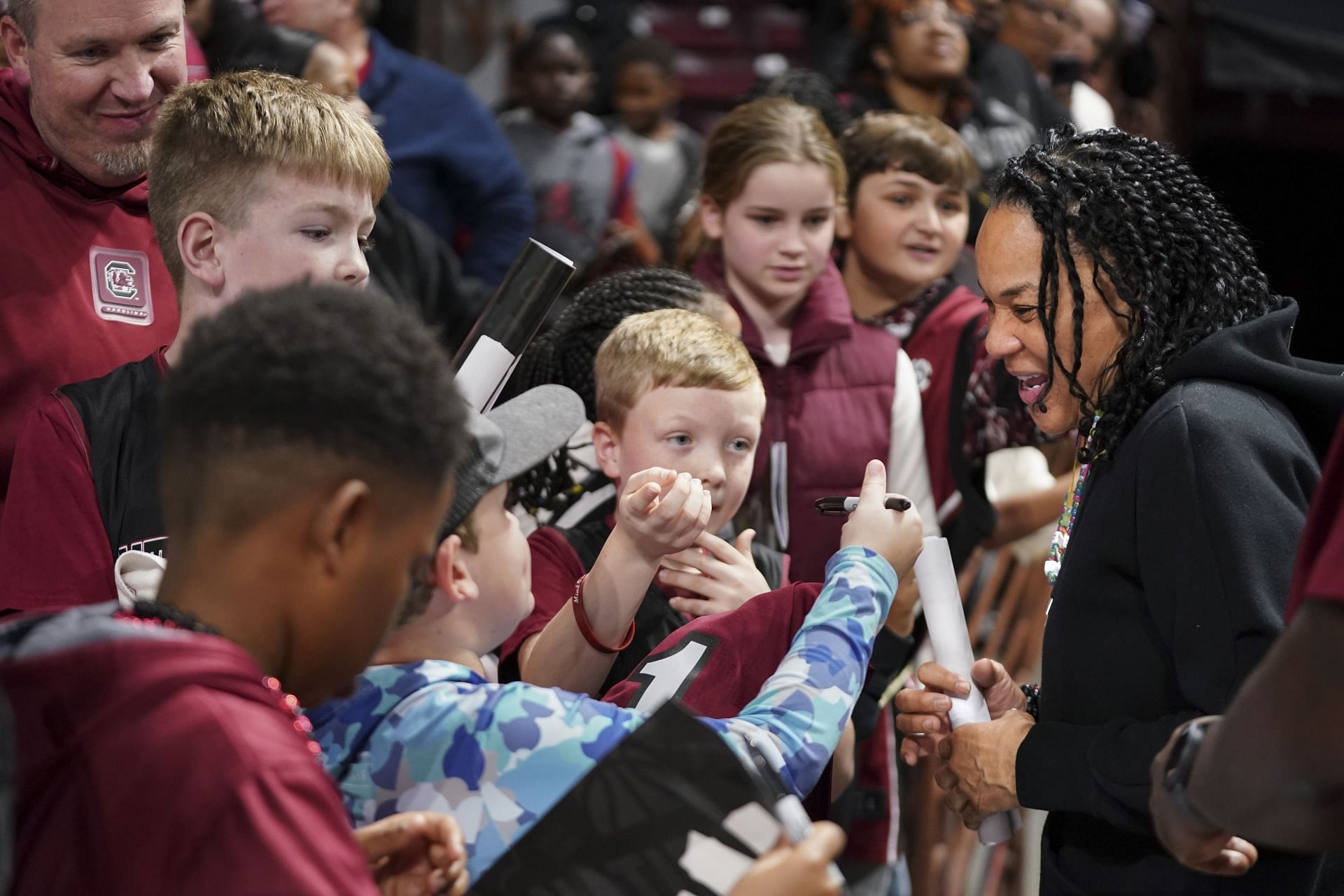 Head coach Dawn Staley of the South Carolina Gamecocks visits children after their game against the South Florida Bulls at Colonial Life Arena in Columbia, South Carolina. Photo: Getty