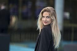 Alica Schmidt turns up the glamour in all white outfit with a sweater ahead of the holiday season