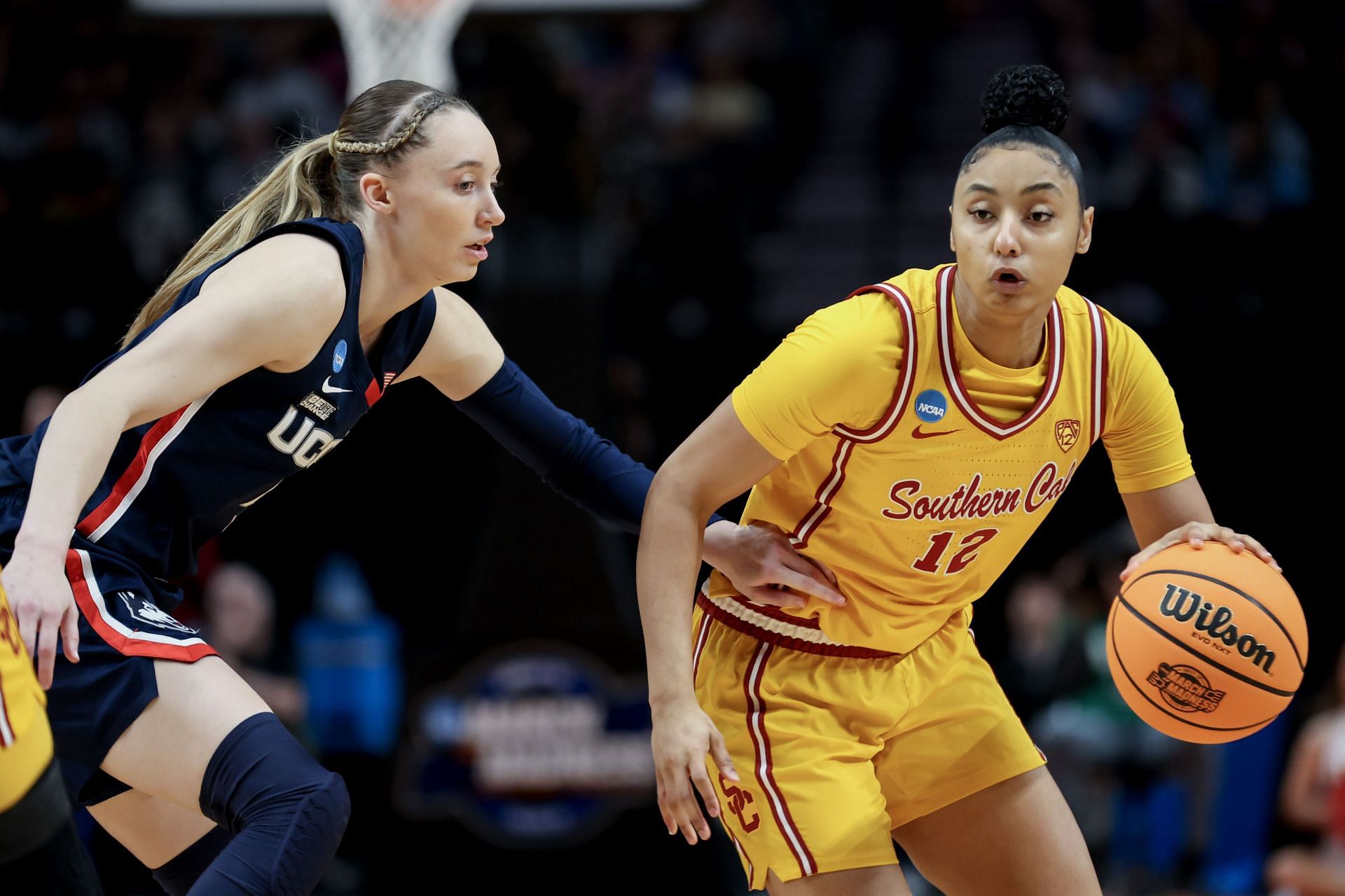 JuJu Watkins (#12) of the USC Trojans drives past Paige Bueckers (#5) of the Connecticut Huskies during the first half of their Elite Eight clash at Moda Center on April 01, 2024 in Portland, Oregon. Photo: Getty