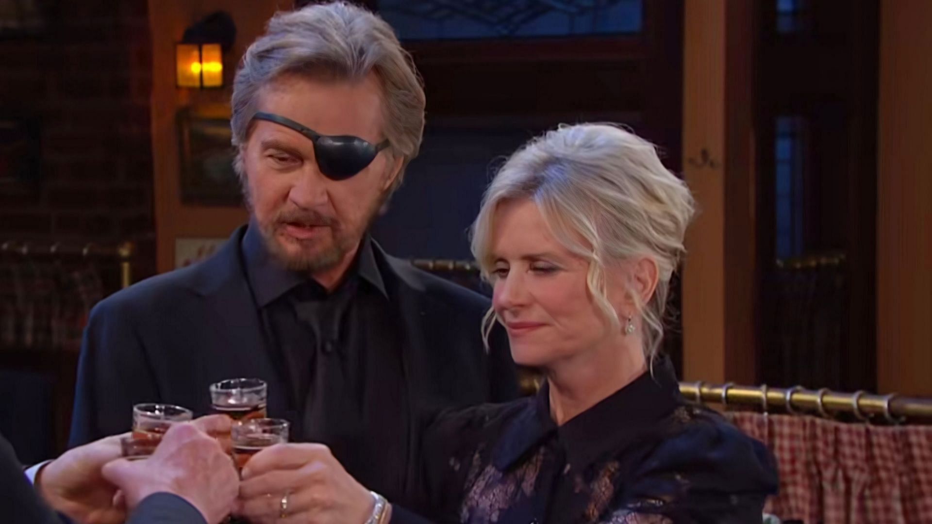 Steve and Kayla Johnson as they toast to Doug&#039;s memory in the promo video for Days of Our Lives (via @dayspeacock / Instagram)