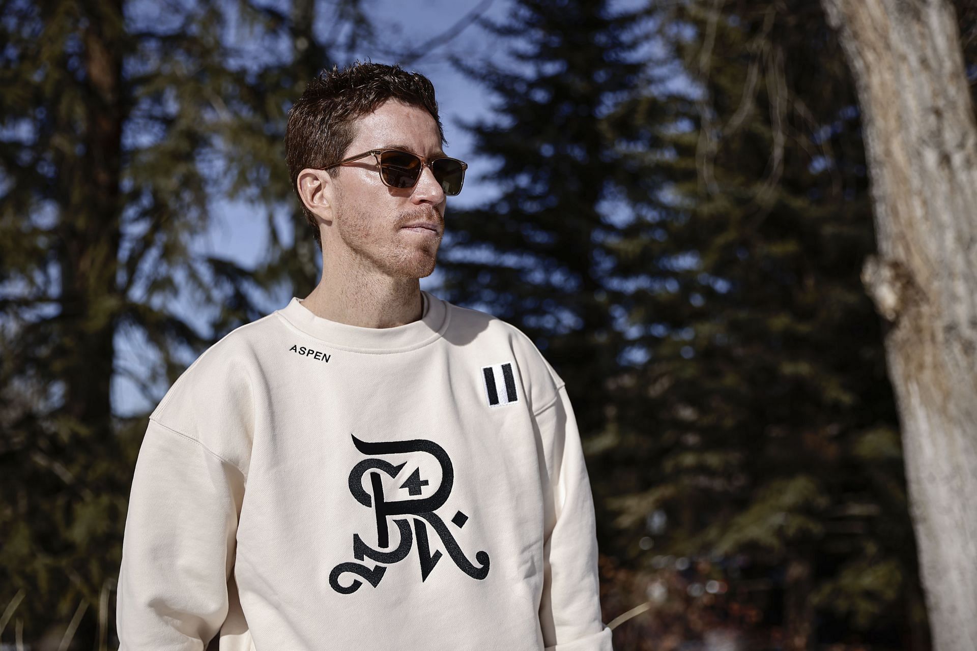 White donning white sweatshirt and black sunglasses during the St Regis Snow Championships in Colorado (Image via: Getty)