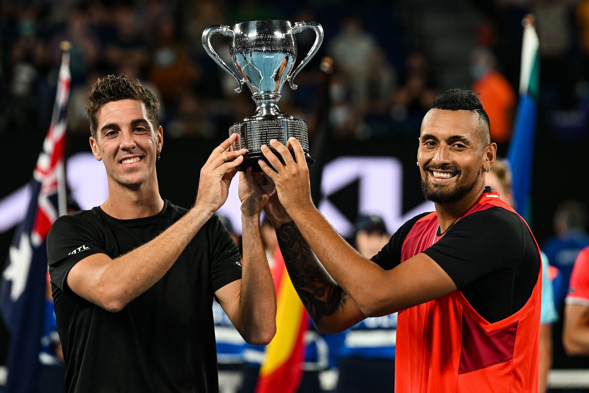 Nick Kyrgios with Thanasi Kokkinakis with the 2022 Australian Open doubles trophy [Source: Getty]