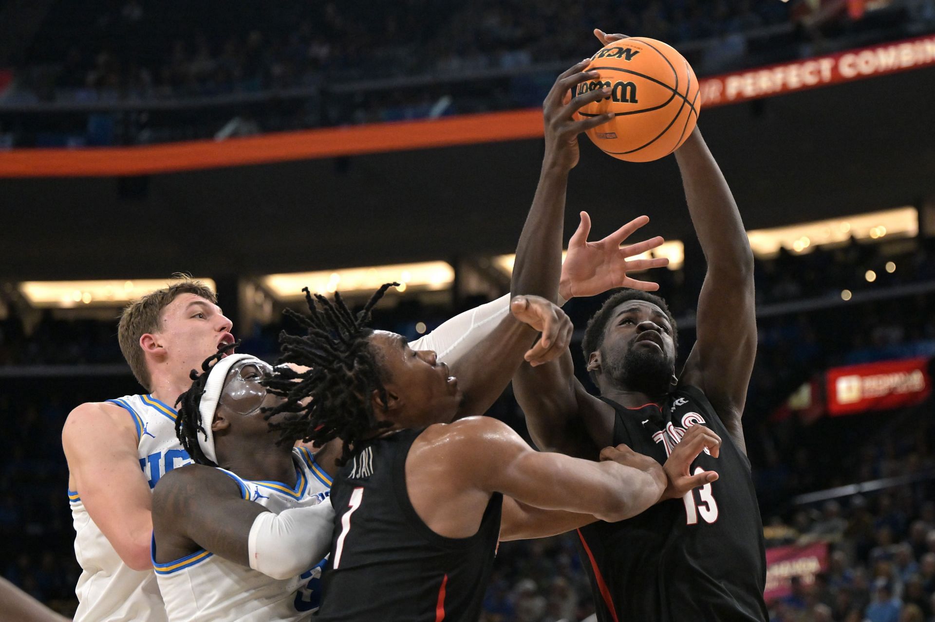 Tyler Bilodeau (#34) and Eric Dailey Jr. (#3) of the UCLA Bruins and Michael Ajayi (#1) and Graham Ike (#13) of the Gonzaga Bulldogs battle for a rebound at Intuit Dome on December 28, 2024. Photo: Getty