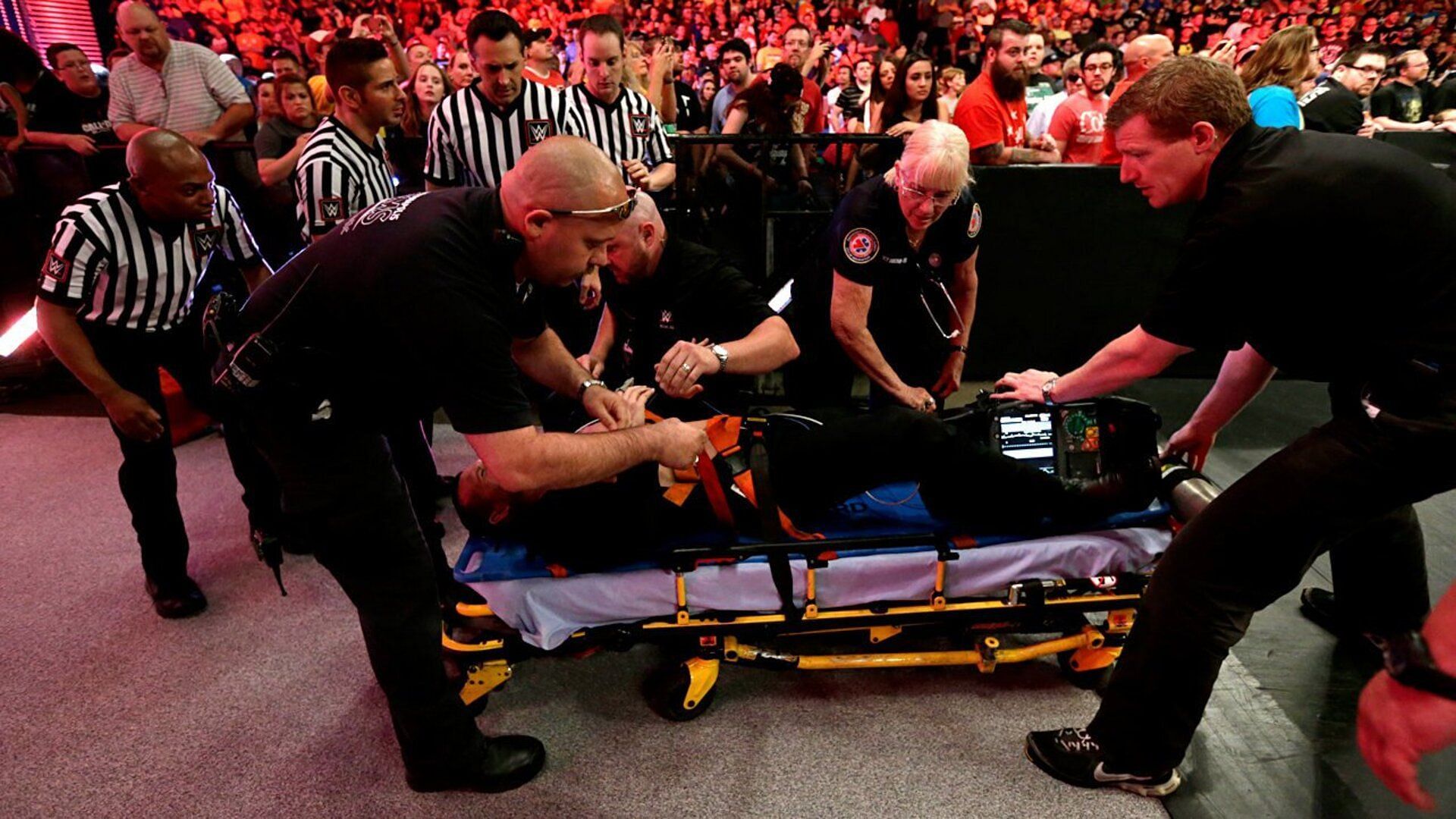 WWE RAW officials and doctors tend to an injury on RAW