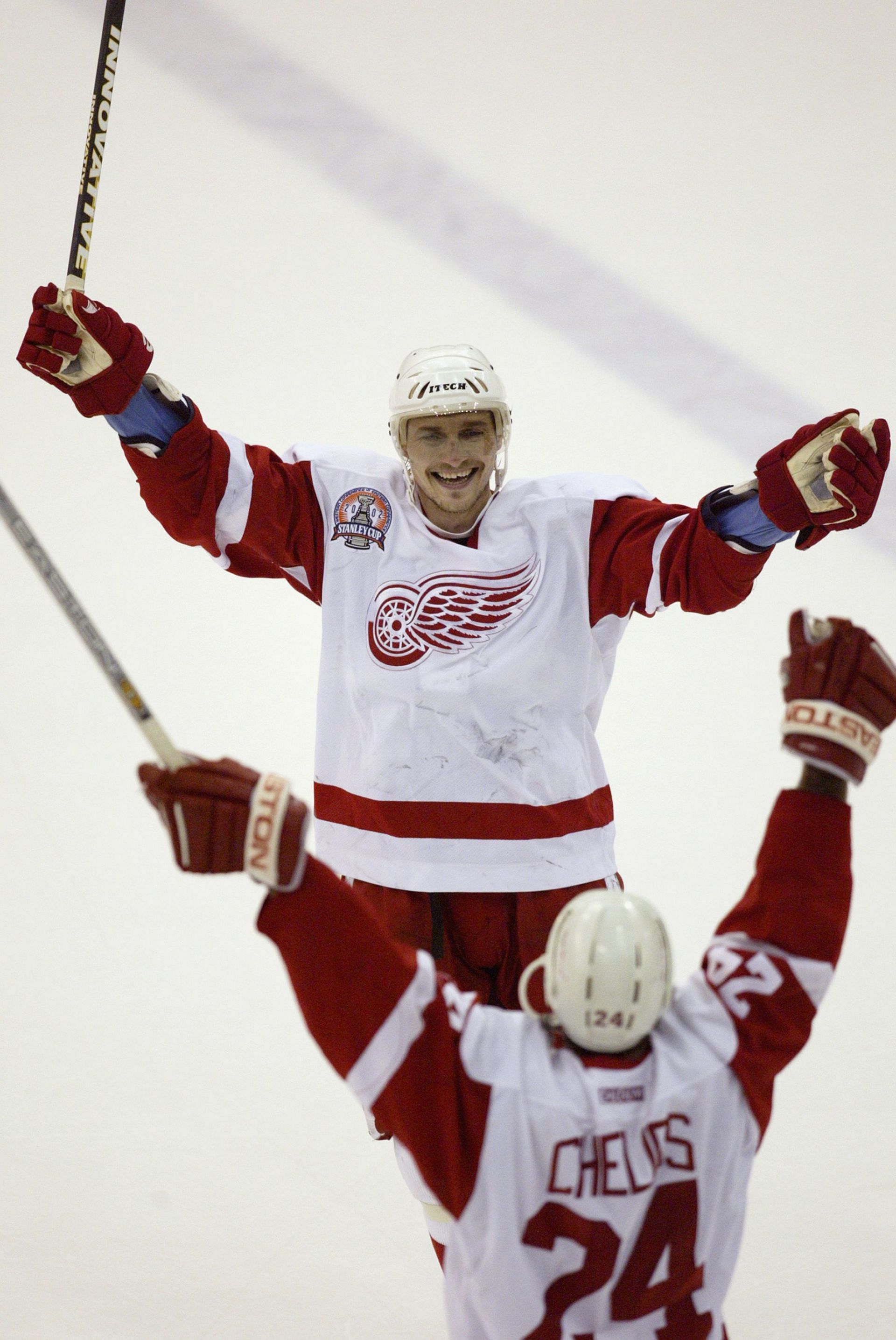 Sergei Fedorov #91 of the Detroit Red Wings celebrates with Chris Chelios #24 after defeating the Carolina Hurricanes to win the Stanley Cup on June 13, 2002 at Joe Louis Arena in Detroit, Michigan. - Source: Getty