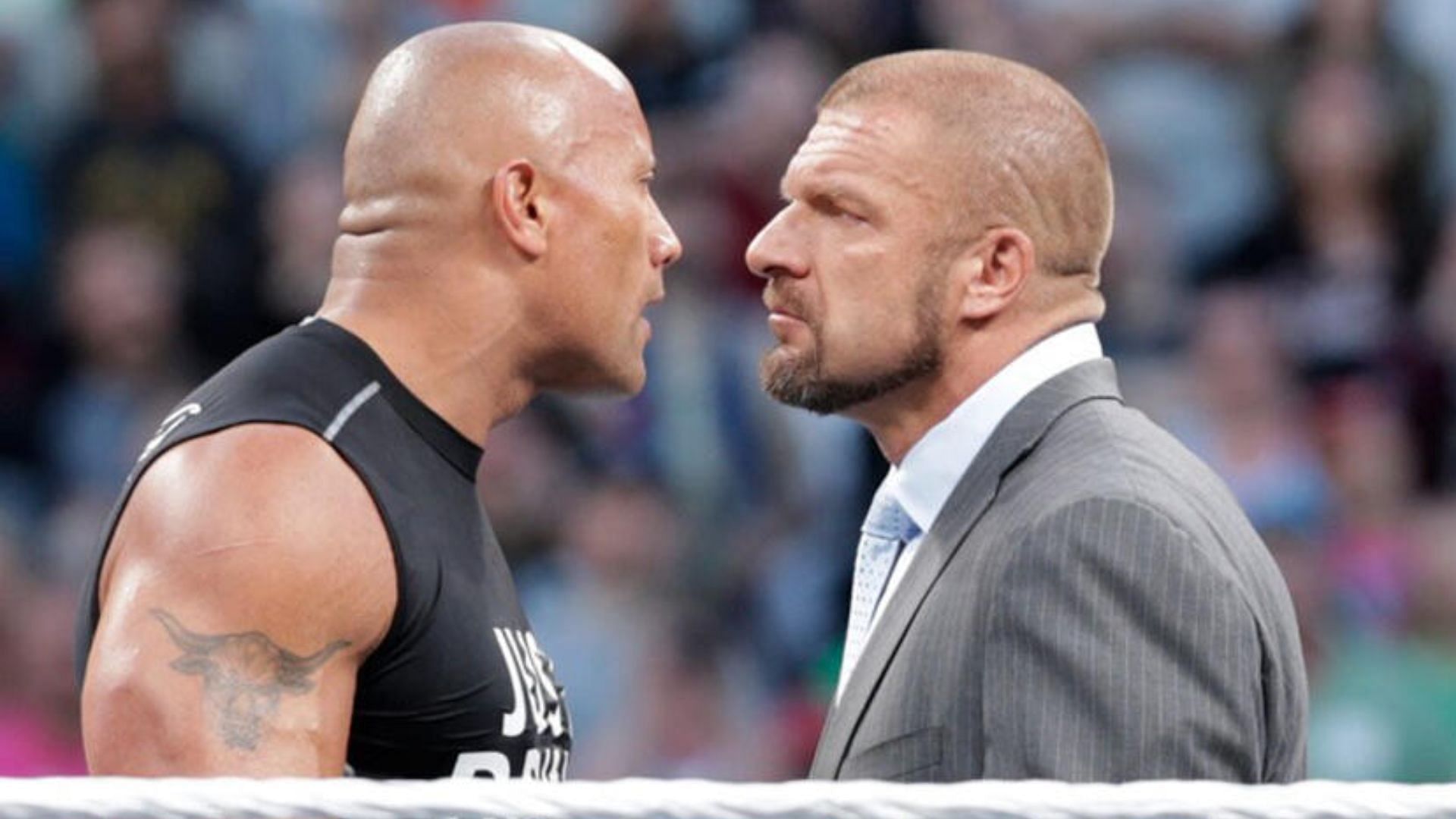 The Rock and Triple H during a confrontation [Image via wwe.com]