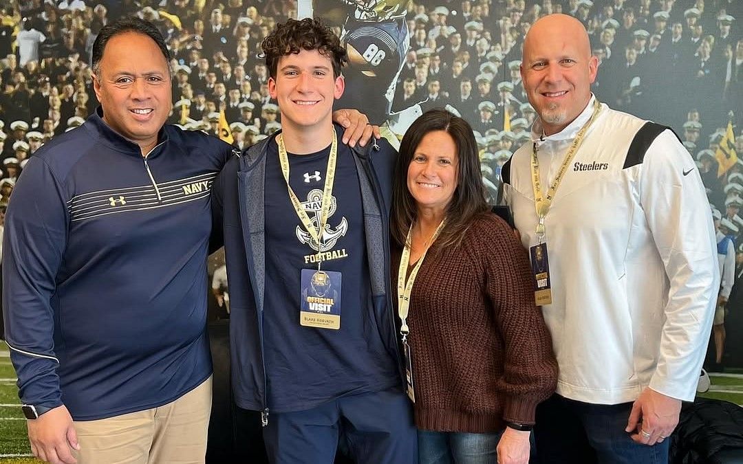 Blake Horvath with his parents and coach