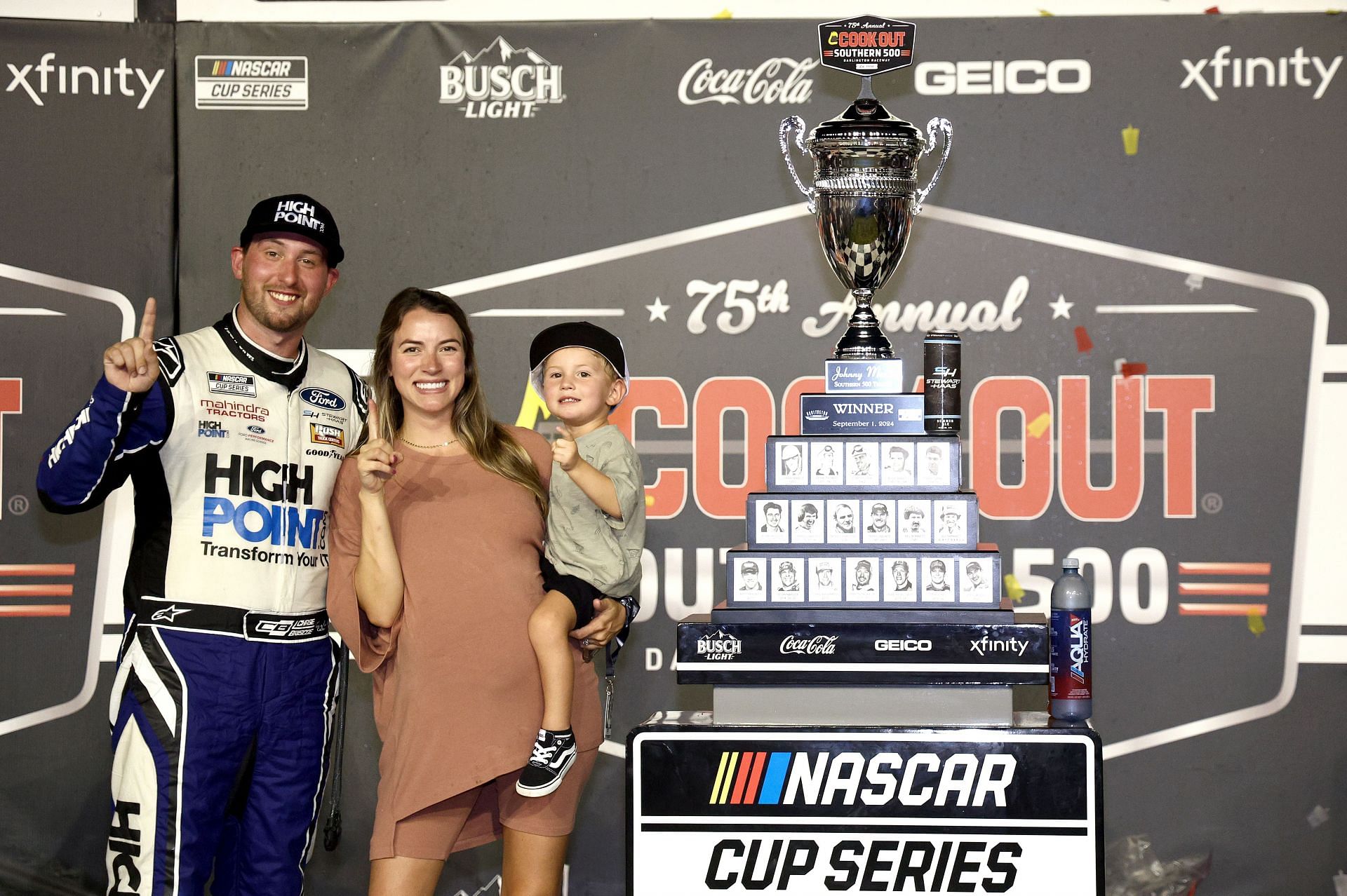 Chase Briscoe, celebrates with his wife Marissa and son, Brooks in victory lane after winning the NASCAR Cup Series Cook Out Southern 500 - Source: Getty