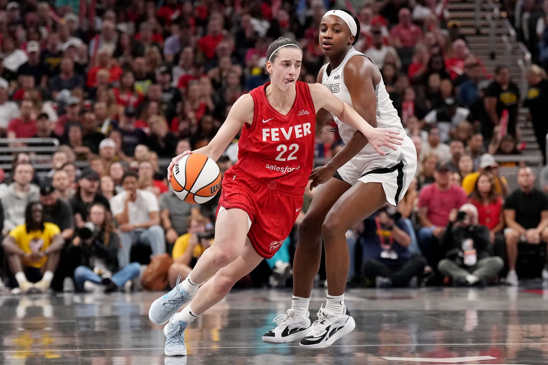 Caitlin Clark of the Indiana Fever drives against Jackie Young of the Las Vegas Aces - Source: Getty