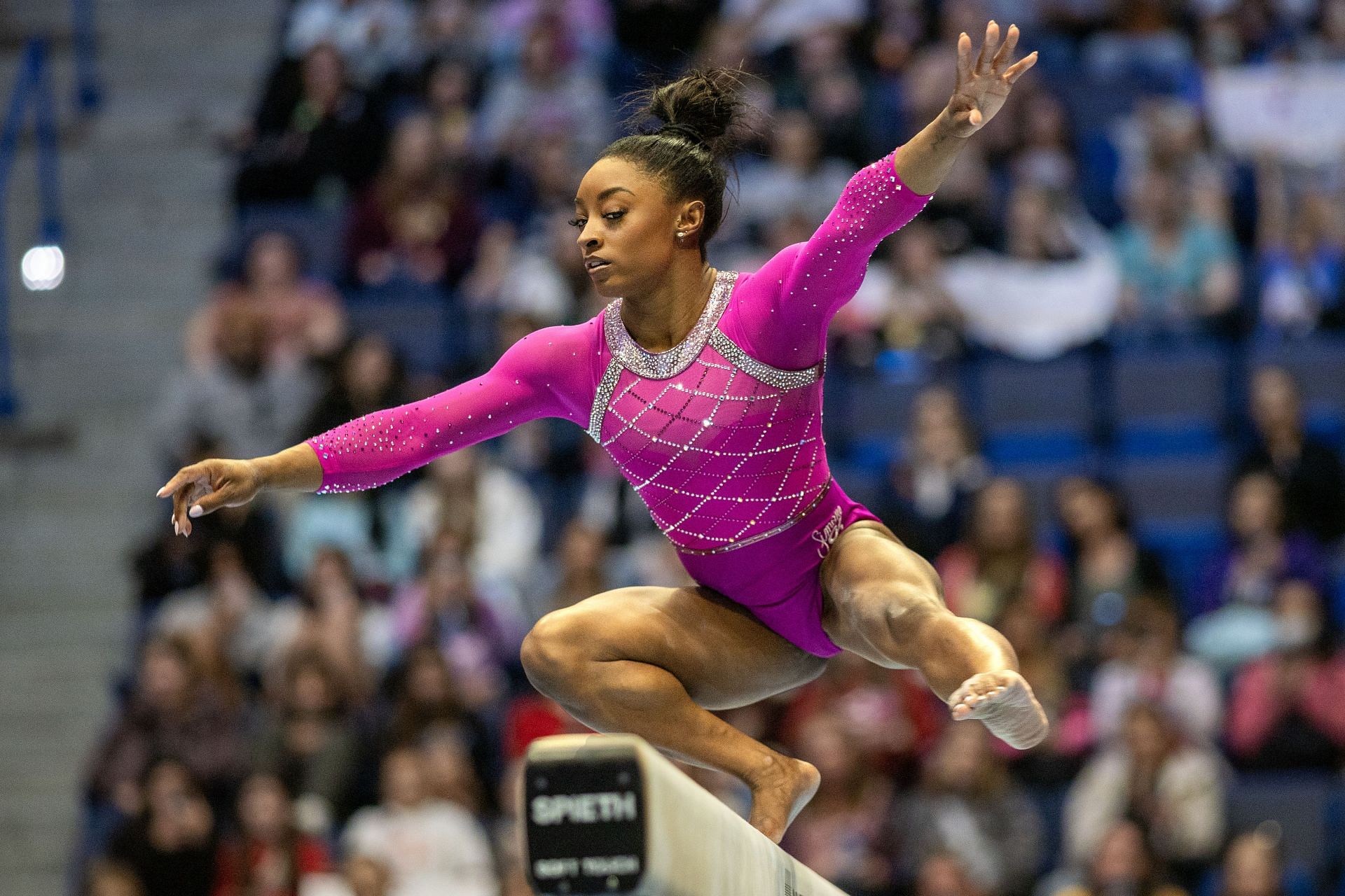 Biles in a pink leotard during her beam balance performance at the 2024 Core Hydration Classic in Hartford (Image via: Getty Images)