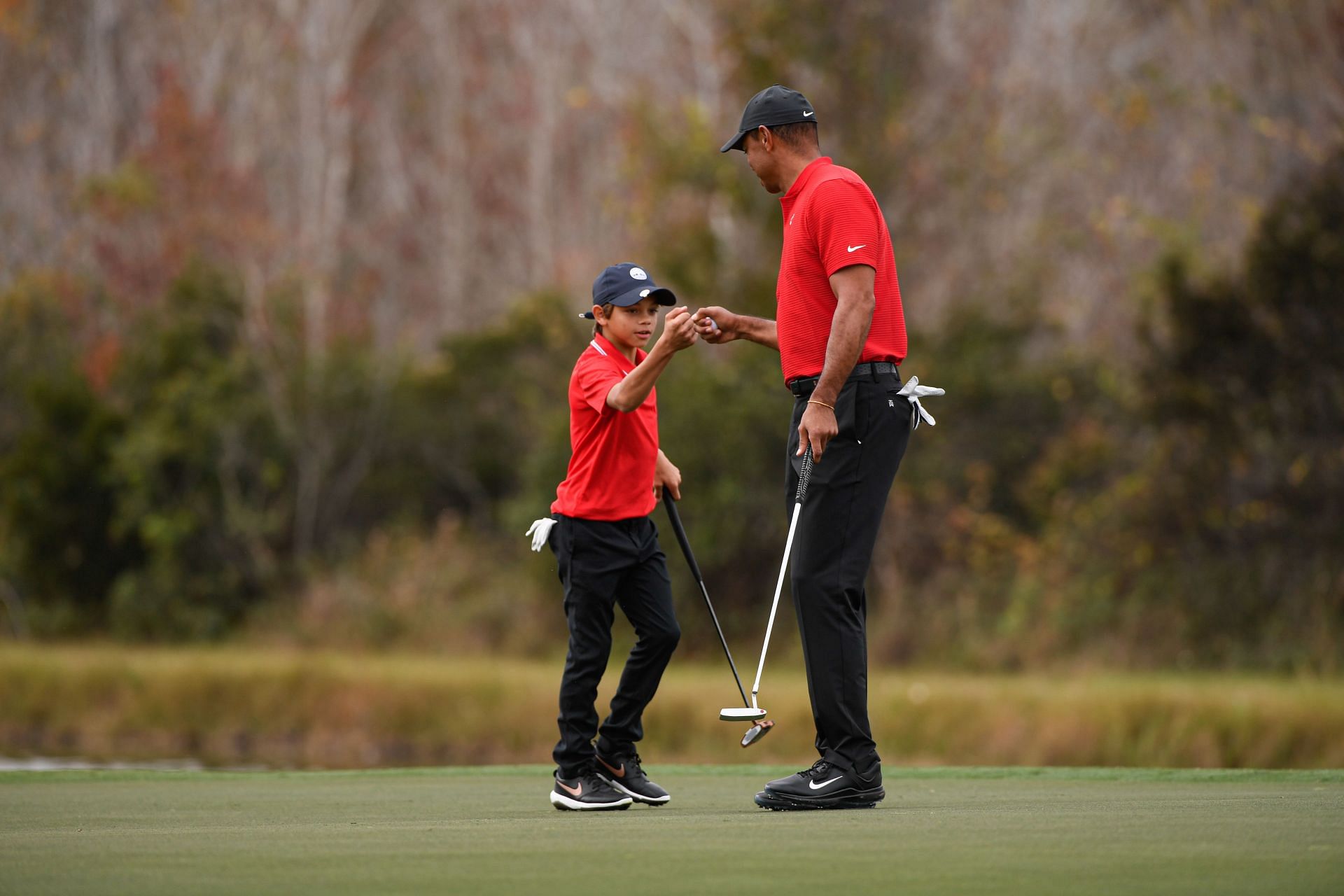  Charlie Woods fist bumps with Tiger Woods, during the final round of the PGA TOUR Champions PNC Championship 2020 - Source: Getty