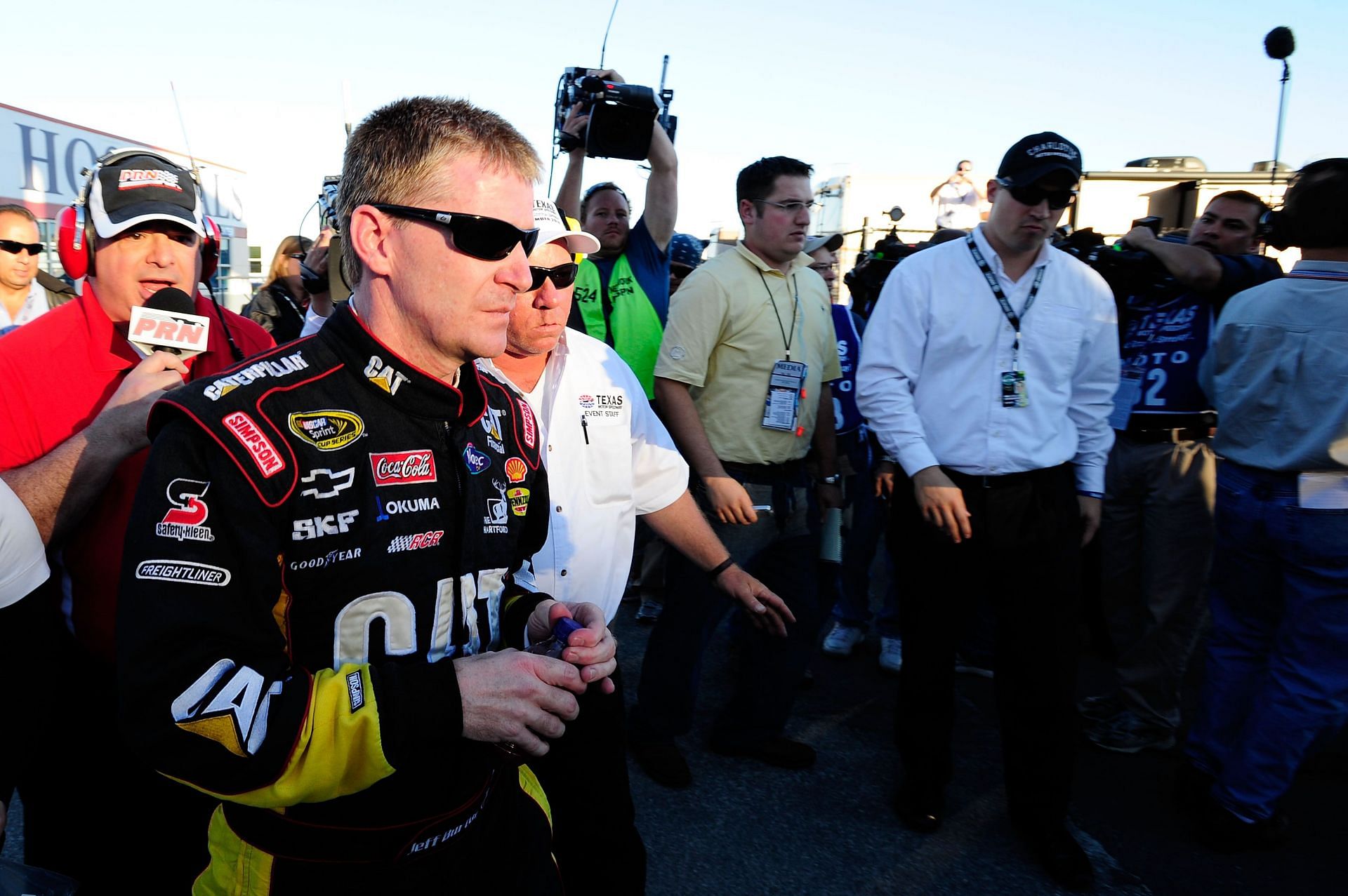  Jeff Burton talks to the media as he walks from the infield care center after the incident with Jeff Gordon in the Texas 500 - Source: Getty