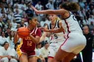 JuJu Watkins #12 of the USC Trojans is defended by Paige Bueckers #5 and Ice Brady #25 of the Connecticut Huskies - Source: Getty