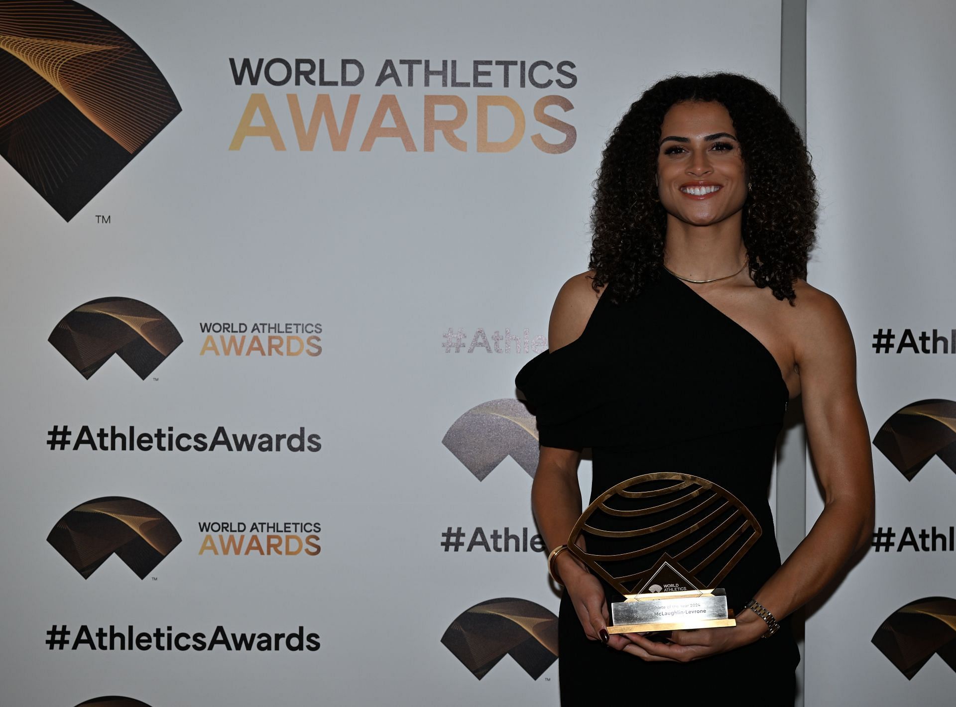 McLaughlin-Levrone posing in a black dress with her award in Monaco during the 2024 World Athletics awards (Image via: Getty Images)