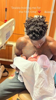 Tyreek Hill holds his daughter Capri