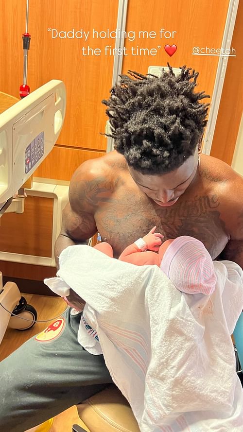 Tyreek Hill holds his daughter Capri