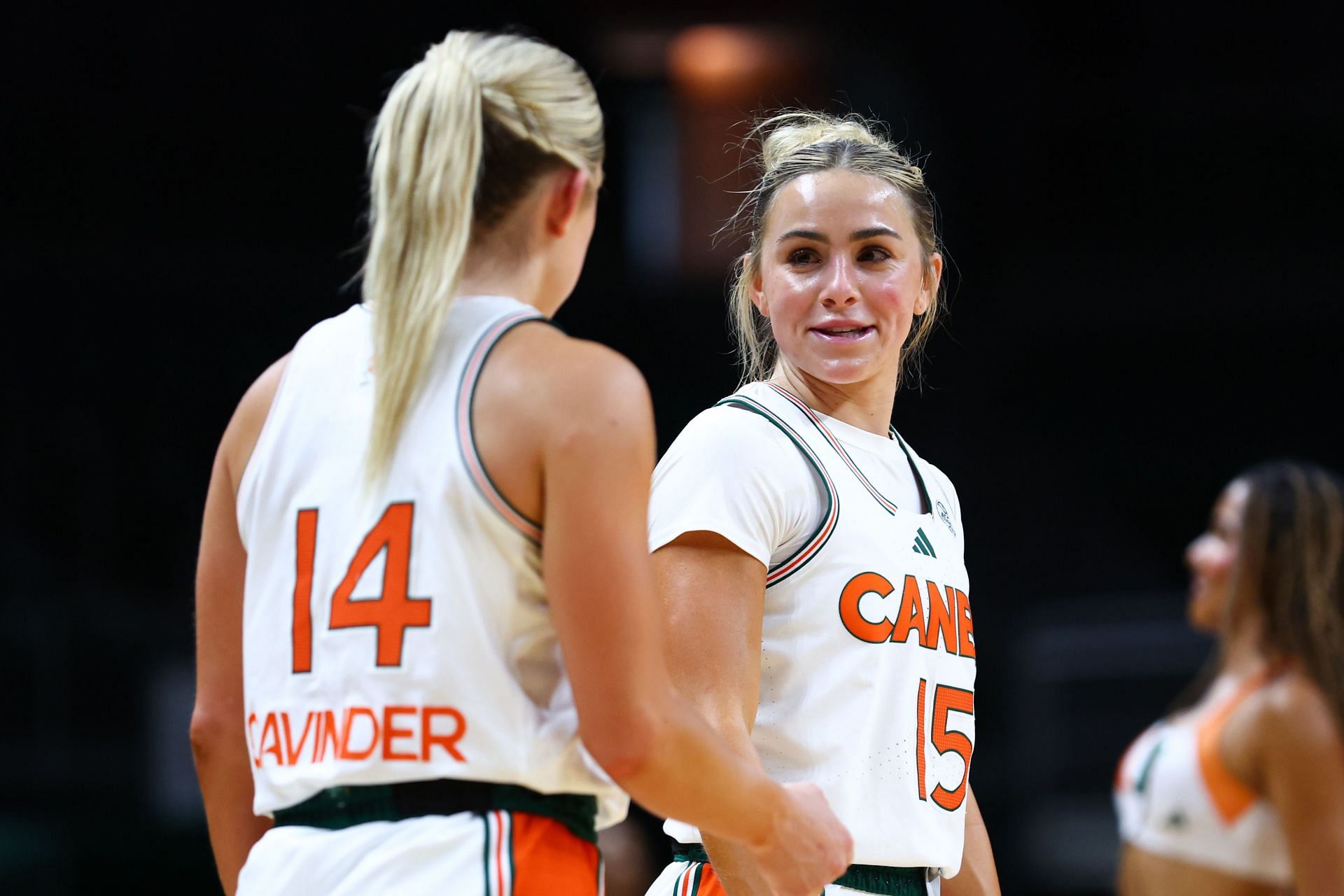 Hanna Cavinder (#15) and Haley Cavinder (#14) of the Miami Hurricanes talk on the court during the second half of their NCAA game against the Jacksonville Dolphins at Watsco Center (Photo: Getty)