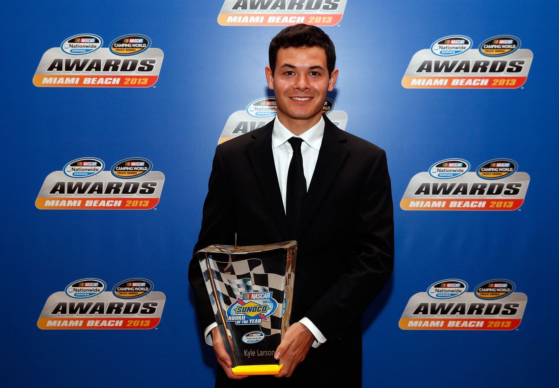 Kyle Larson poses with his Rookie of the Year trophy during the NASCAR Nationwide Series/Camping World Truck Series banquet on November 18, 2013 - Source: Getty