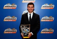 Kyle Larson poses with his Rookie of the Year trophy during the NASCAR Nationwide Series/Camping World Truck Series banquet on November 18, 2013 - Source: Getty