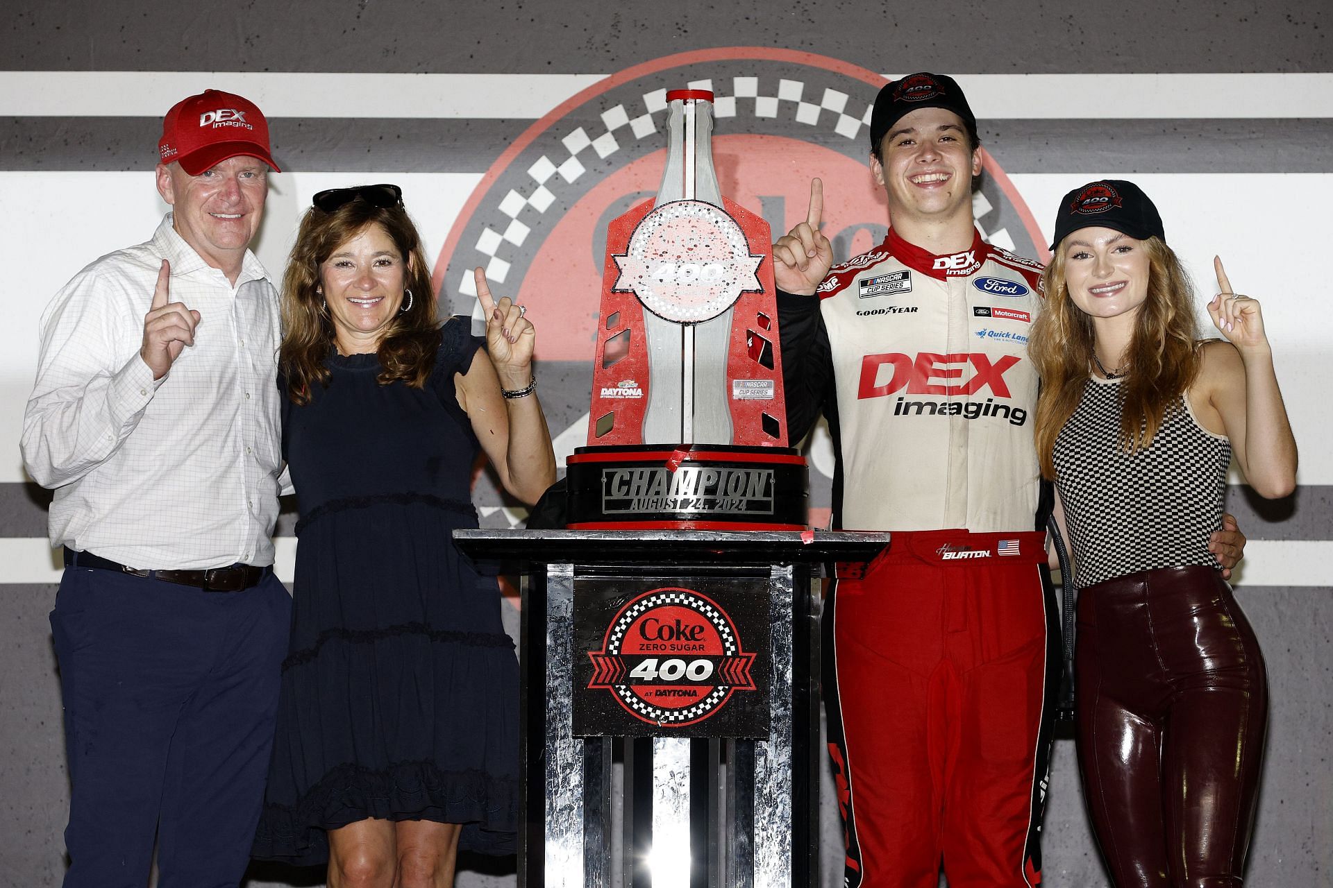 Harrison Burton (2nd from right), driver of the #21 DEX Imaging Ford, celebrates with his father, Jeff Burton (L), mother, Kim Burton, and fiancee, Jenna Petty (R) - Source: Getty Images