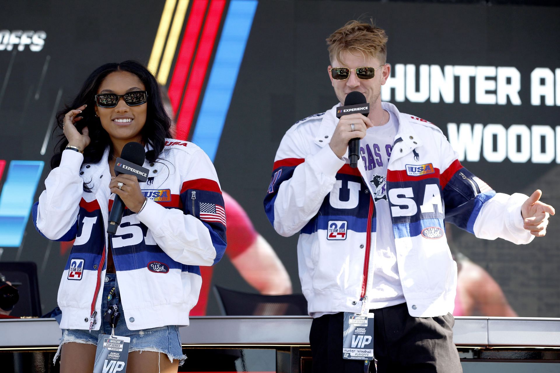 Davis-Woodhall and her husband Hunter Woodhall in white jackets enjoying NASCAR Racing at Arkansas (Image via: Getty Images)