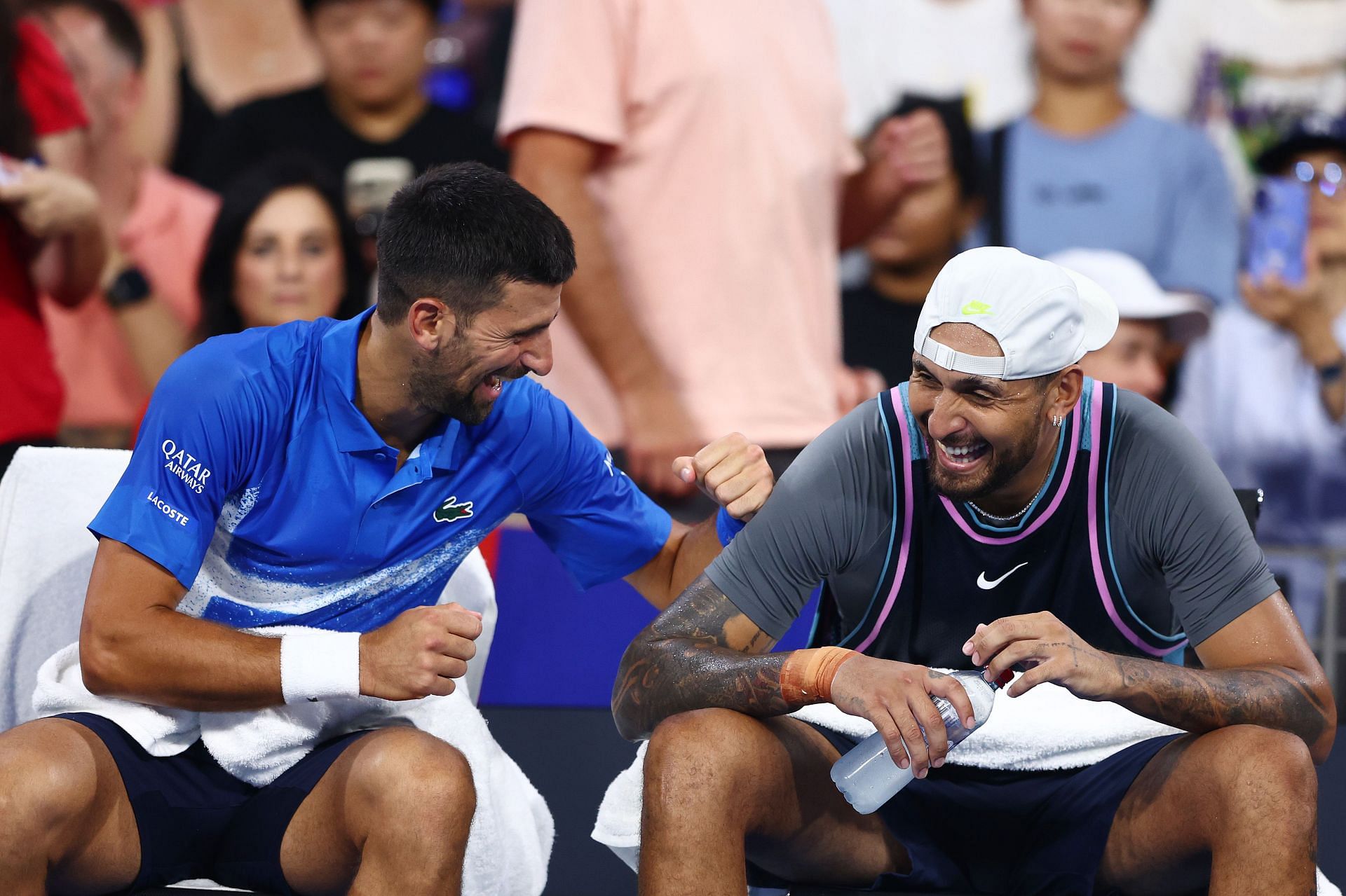 Novak Djokovic (L) and Nick Kyrgios during their first-round doubles encounter at the Brisbane International. (Source: Getty)