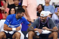 Novak Djokovic (L) and Nick Kyrgios during their first-round doubles encounter at the Brisbane International. (Source: Getty)