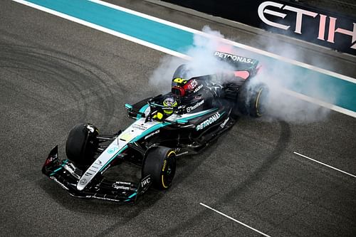 Lewis Hamilton of Great Britain driving the (44) Mercedes AMG Petronas F1 Team W15 does donuts on track during the Abu Dhabi Grand Prix - Source: Getty Images