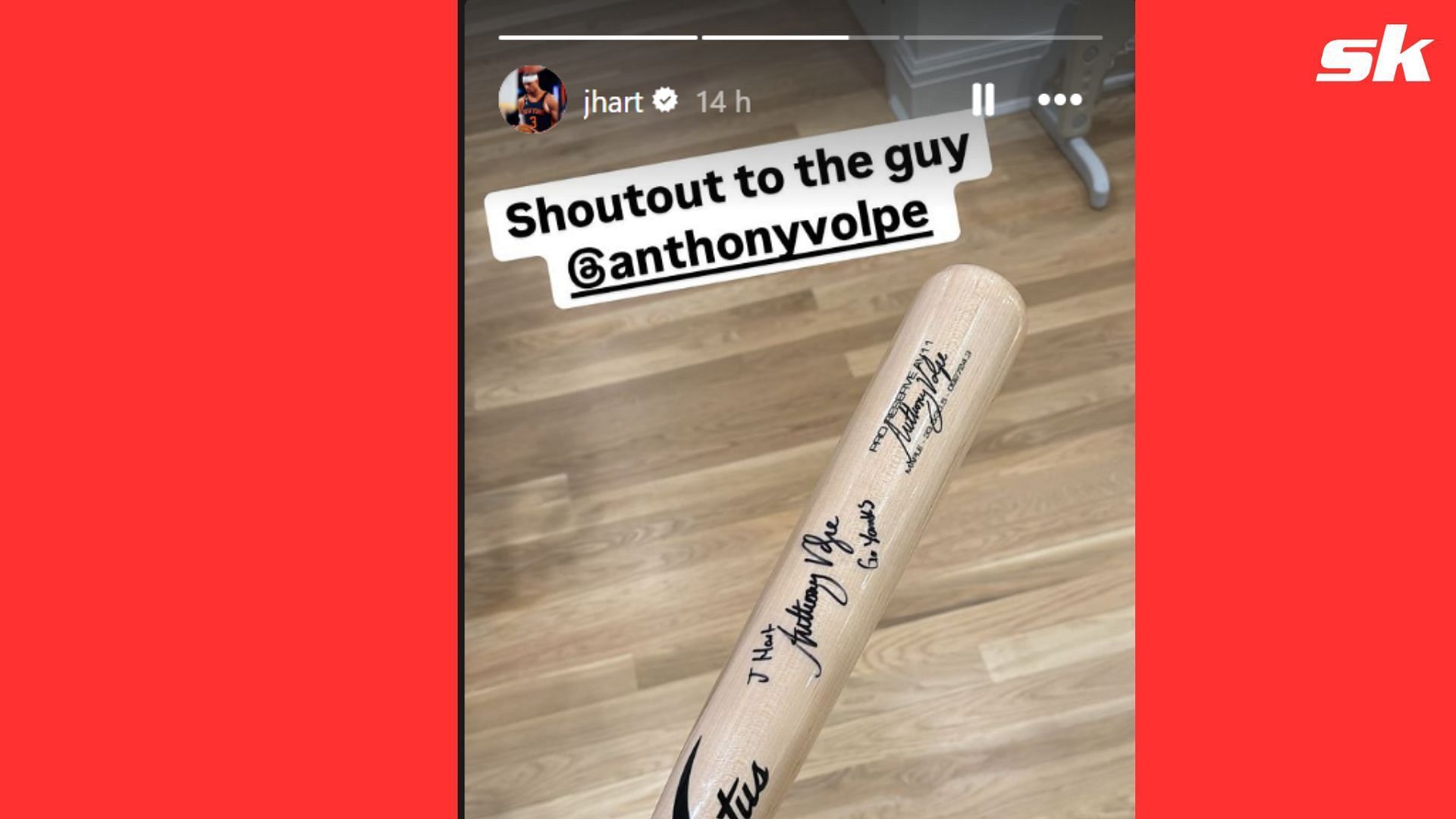 Josh Hart showing off the signed baseball bat given to him by Anthony Volpe